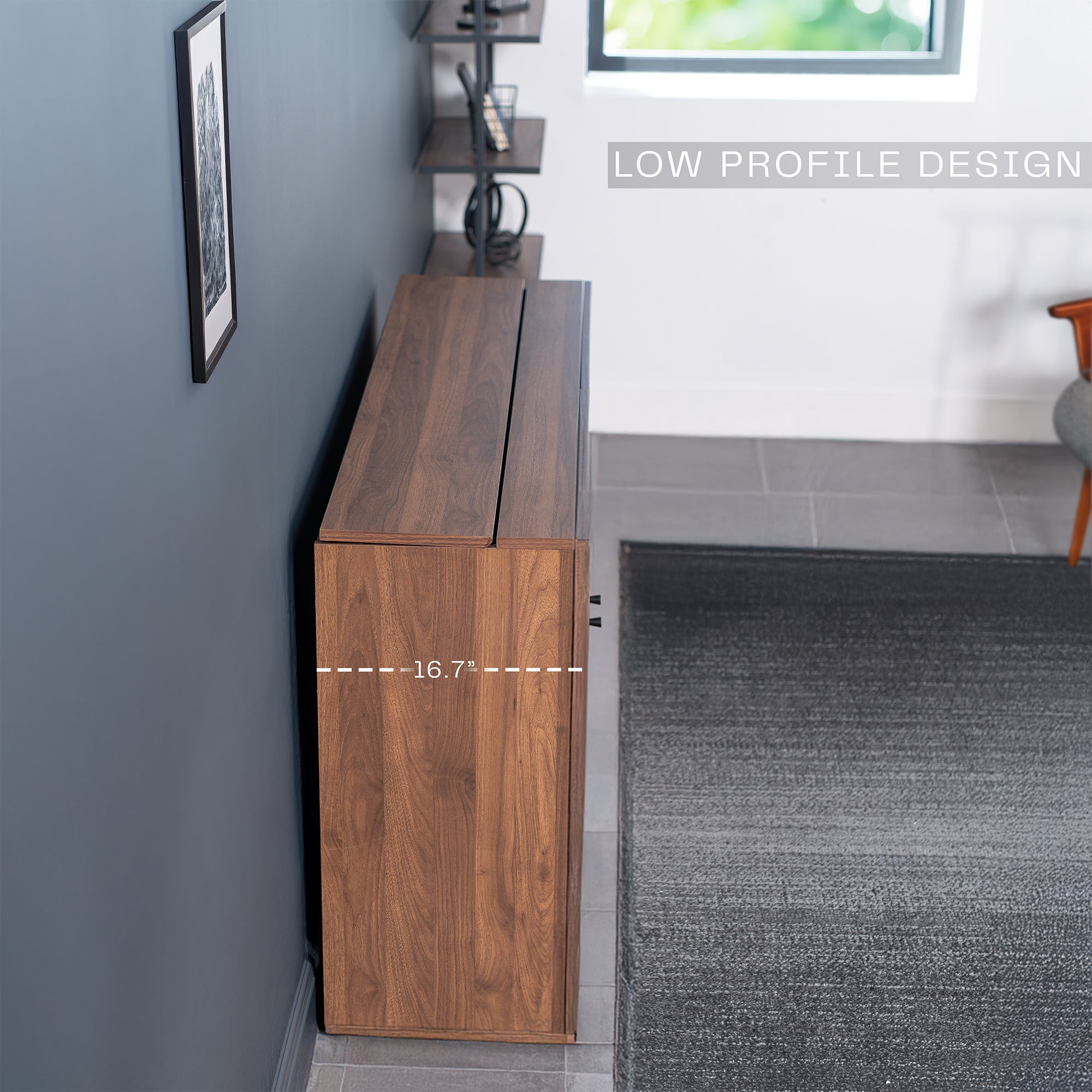 A walnut brown TV lift cabinet with a flat-screen TV mounted on top and a low profile design.