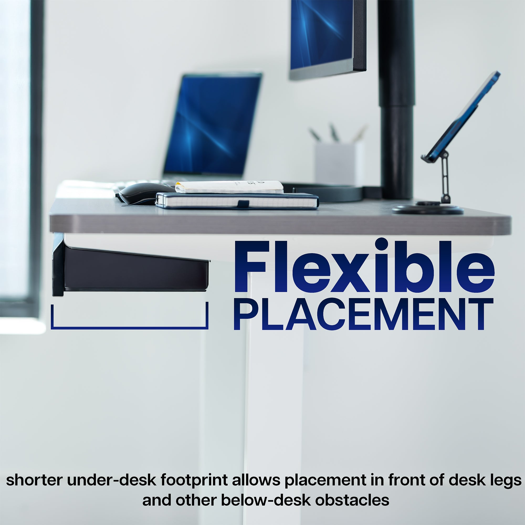 Modern office desk setup with computer monitors and a lamp.