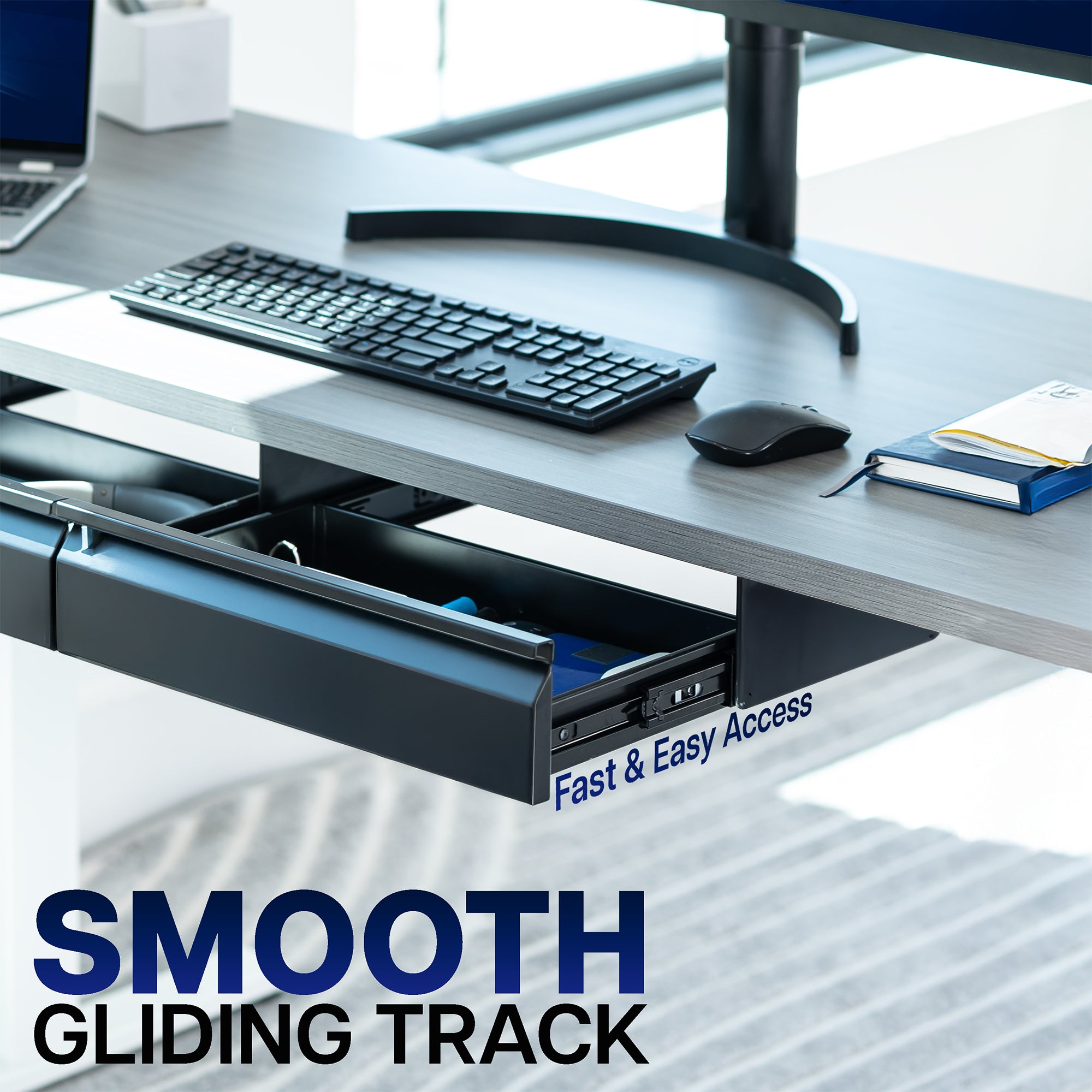 Desk setup with keyboard, mouse, and open drawer labeled on a blurred office background.