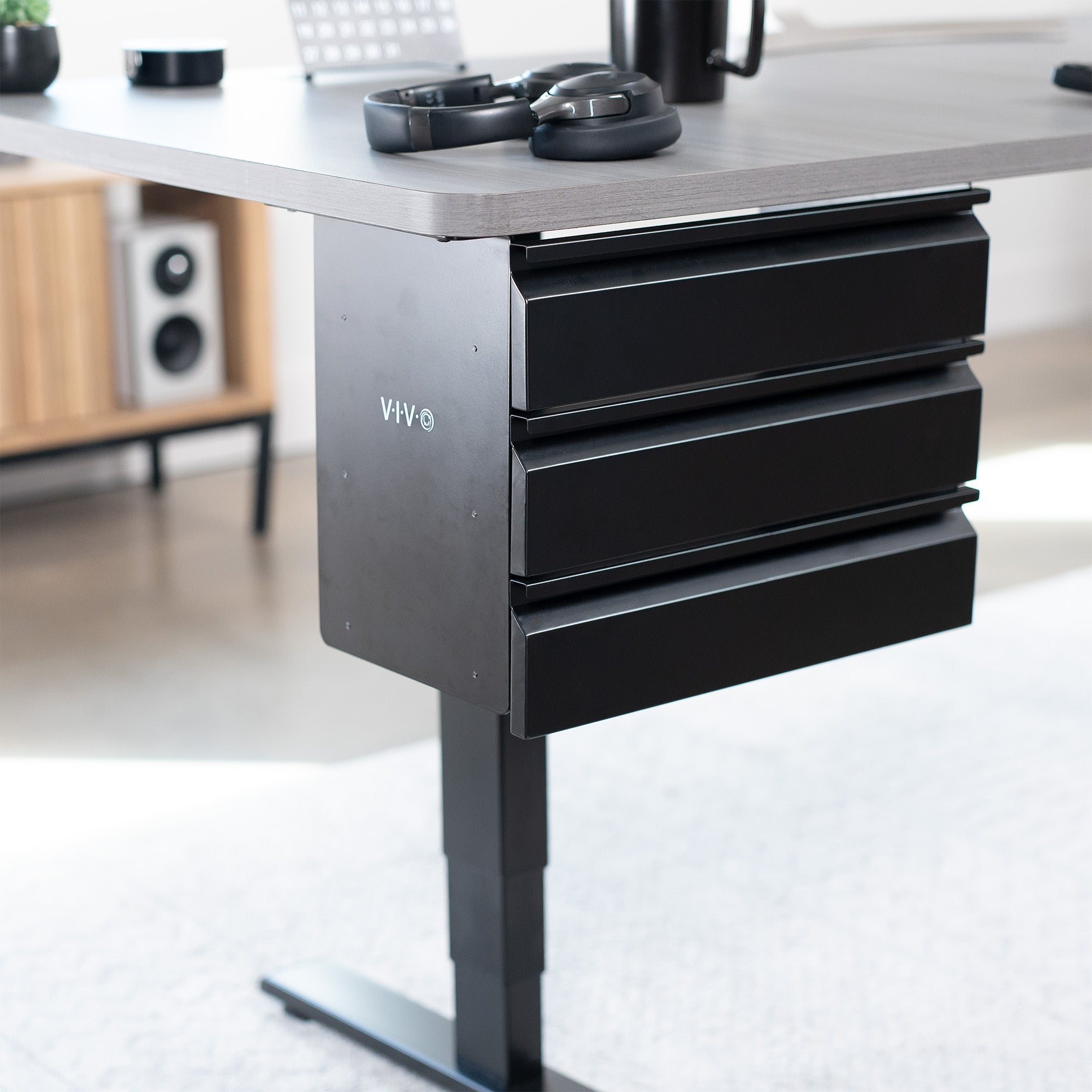 Sleek under desk storage unit with three pull-out drawers for office workstation organization.