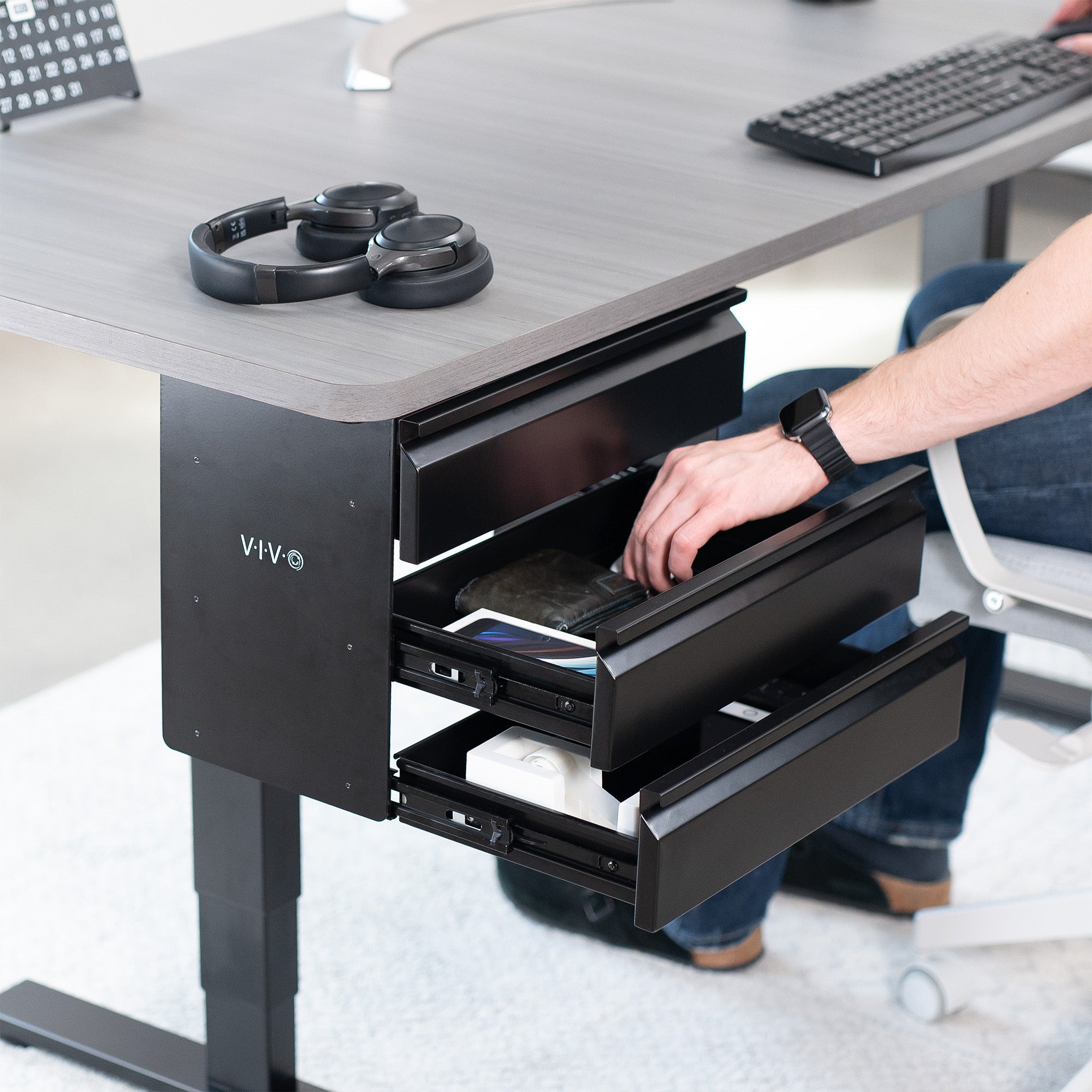 Sleek under desk storage unit with three pull-out drawers for office workstation organization.