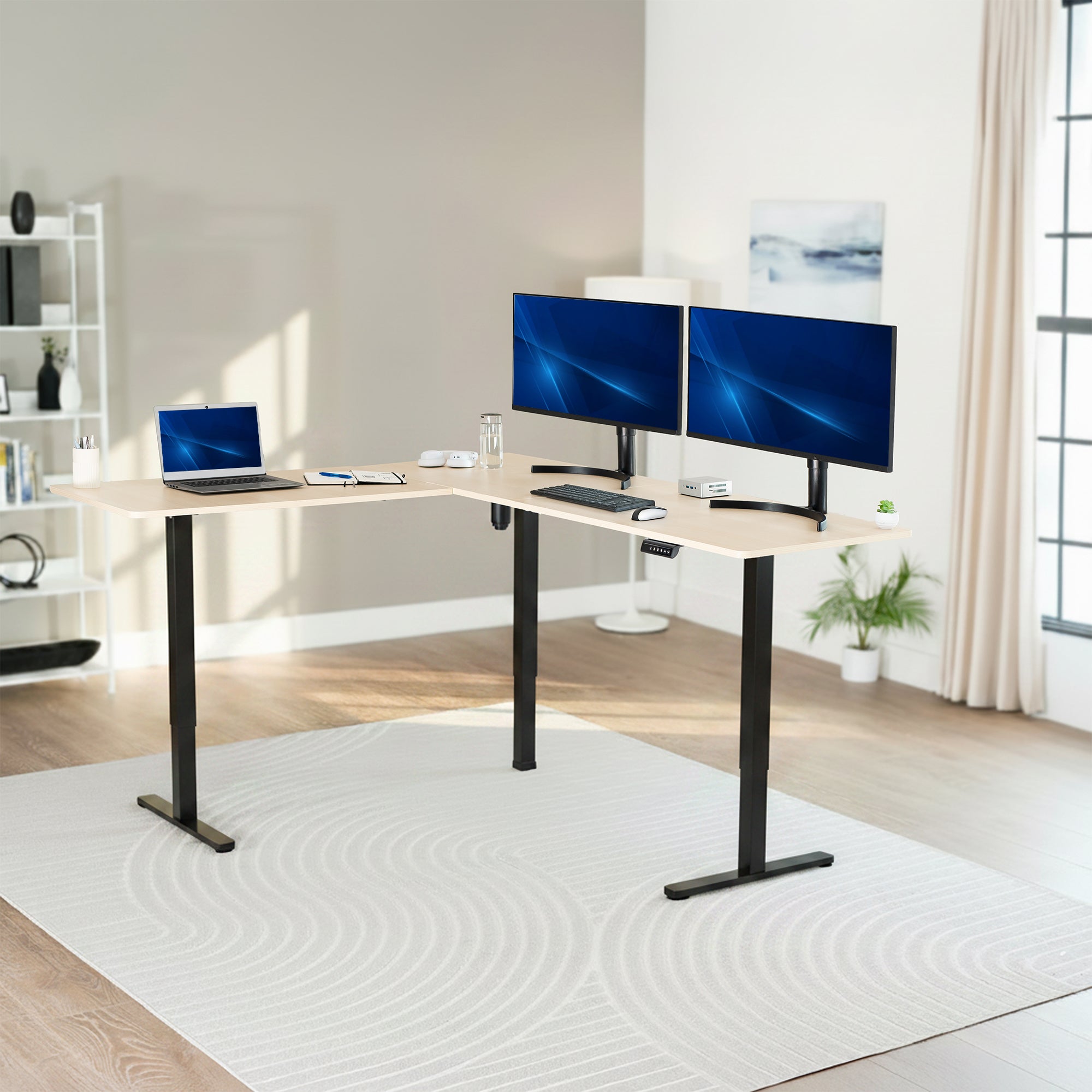 Modern home office with a L-shaped desk, laptop, and two monitors.
