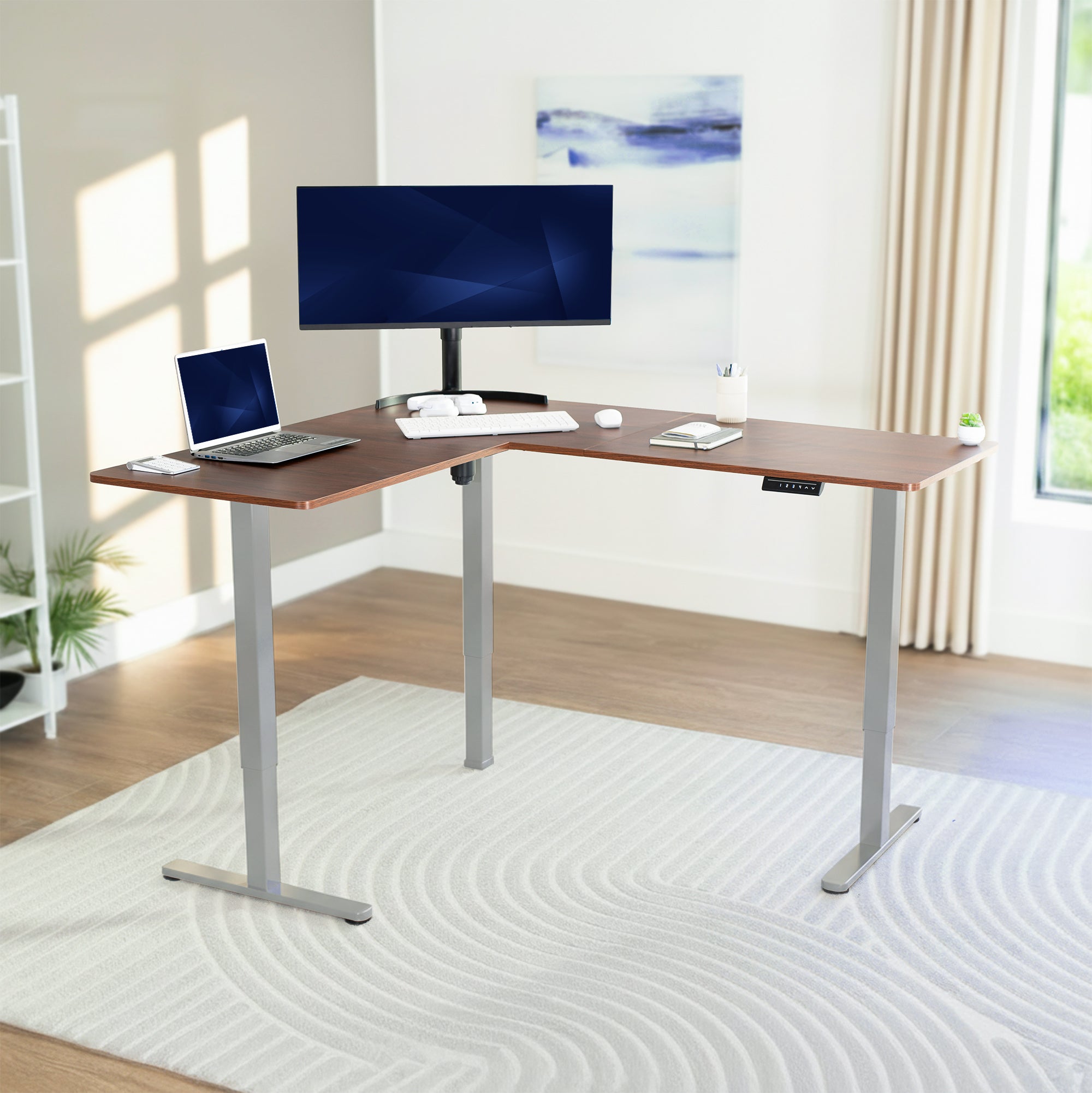 L-shaped desk with computer setup in a bright room