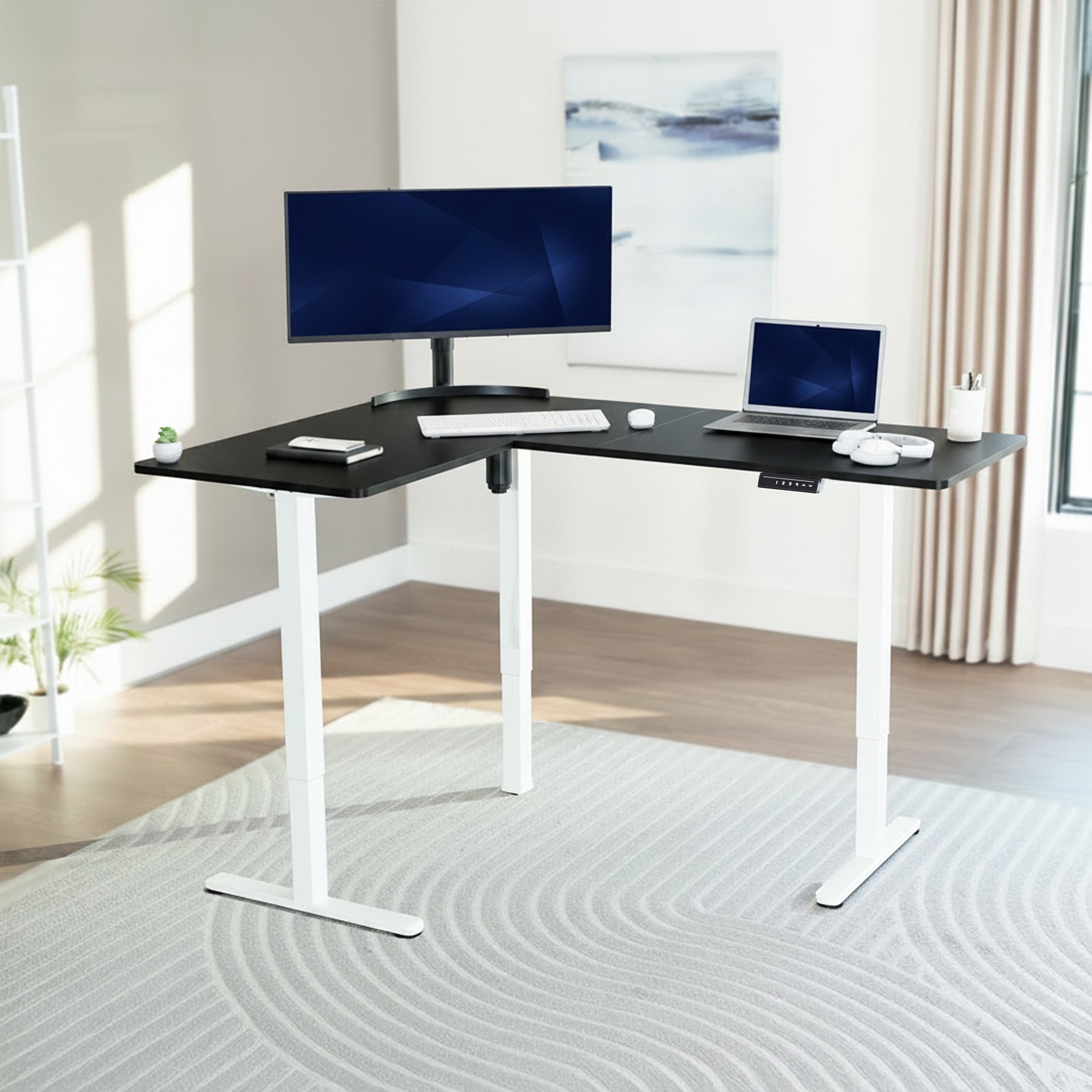 L-shaped desk with computer setup in a bright room