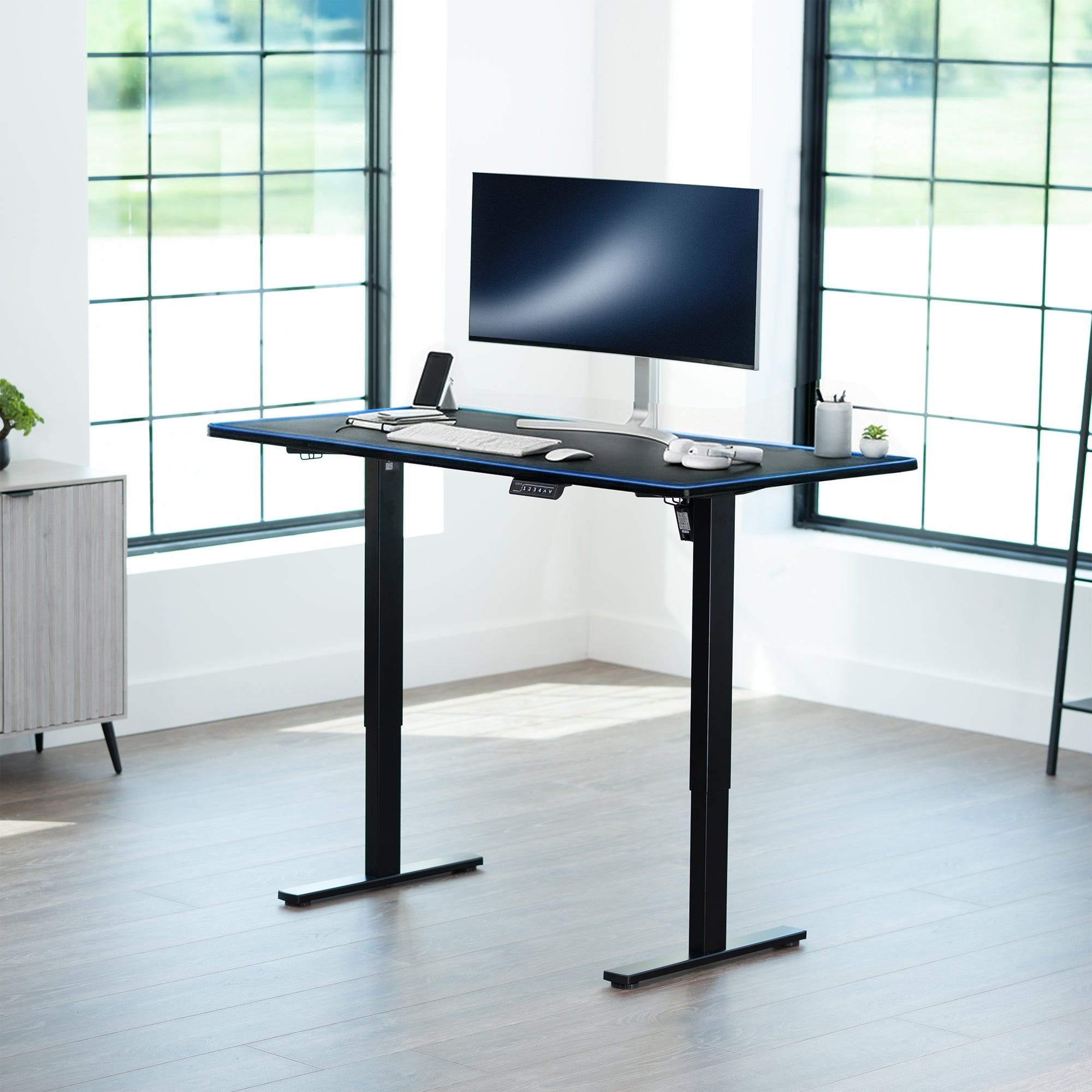 Sturdy ergonomic sit or stand active desk workstation with RGB pad and adjustable height using smart control panel.