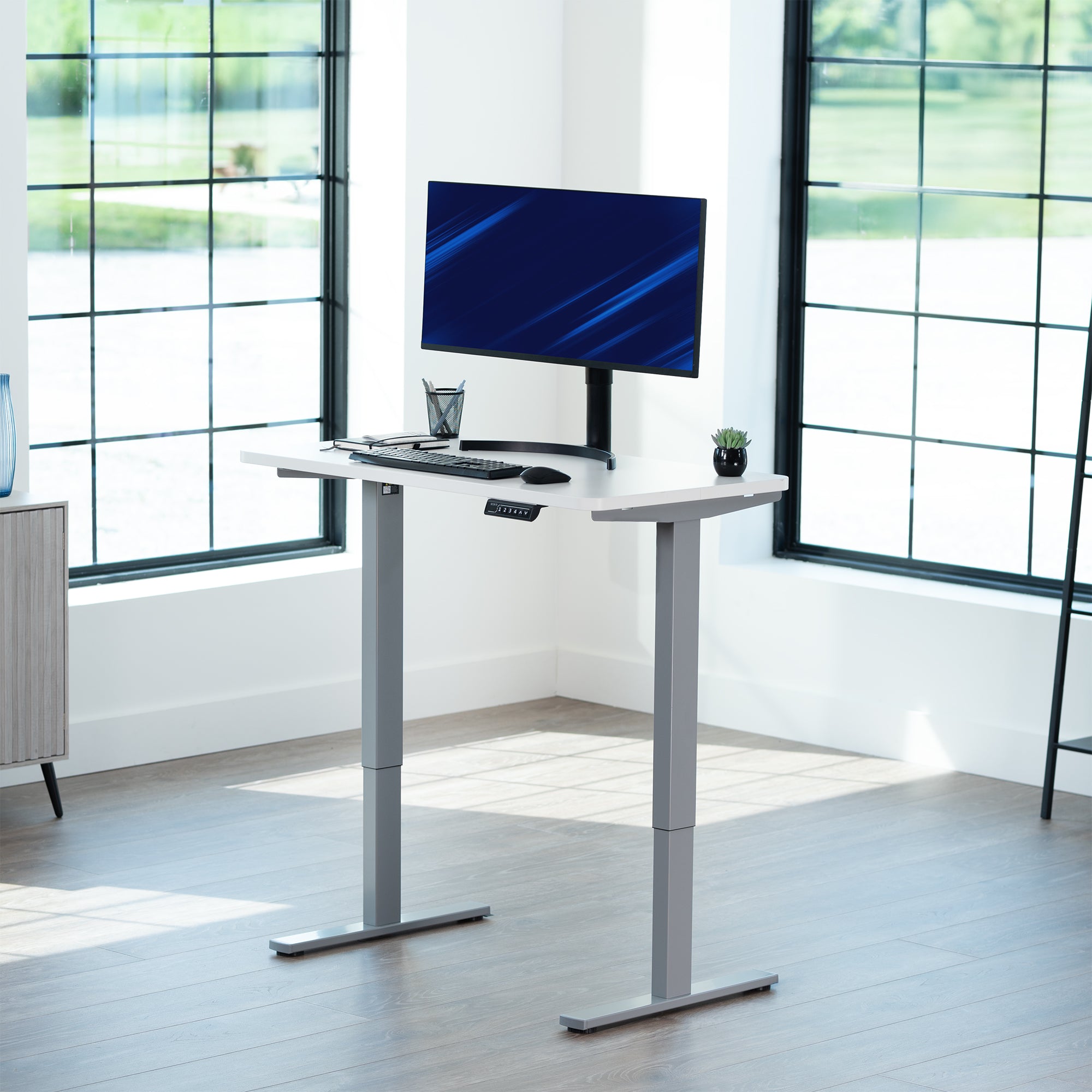 Sturdy ergonomic sit or stand active desk workstation with adjustable height using smart control panel.