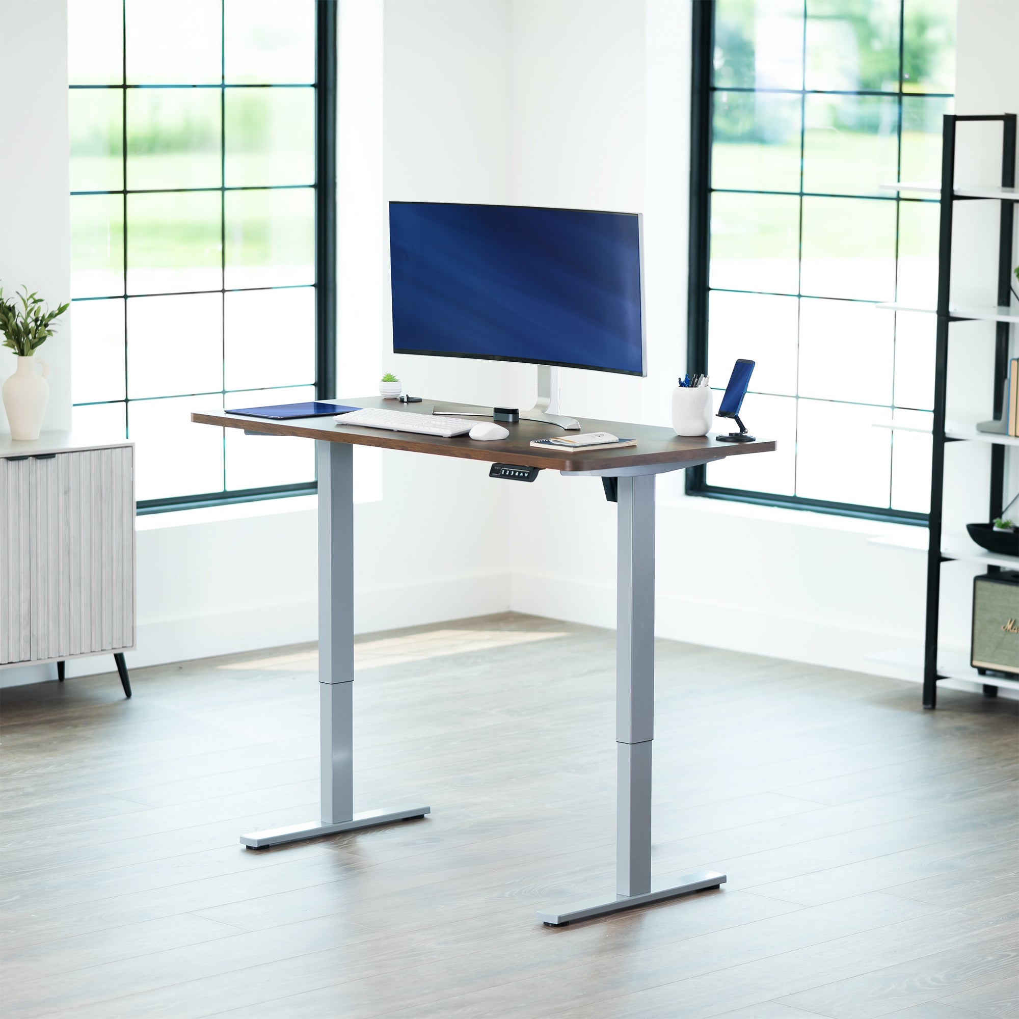 Sturdy ergonomic sit or stand active desk workstation with adjustable height using smart control panel.
