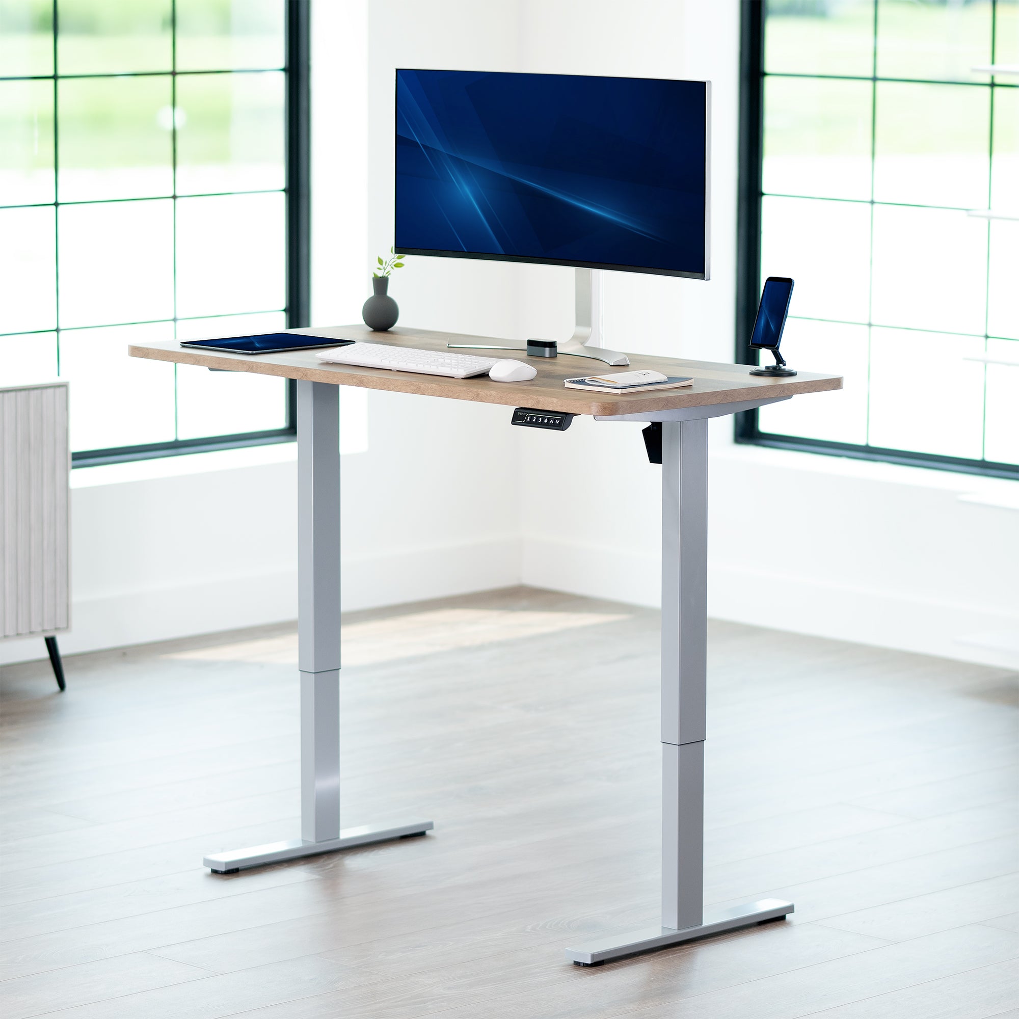 Sturdy ergonomic sit or stand active desk workstation with adjustable height using smart control panel.