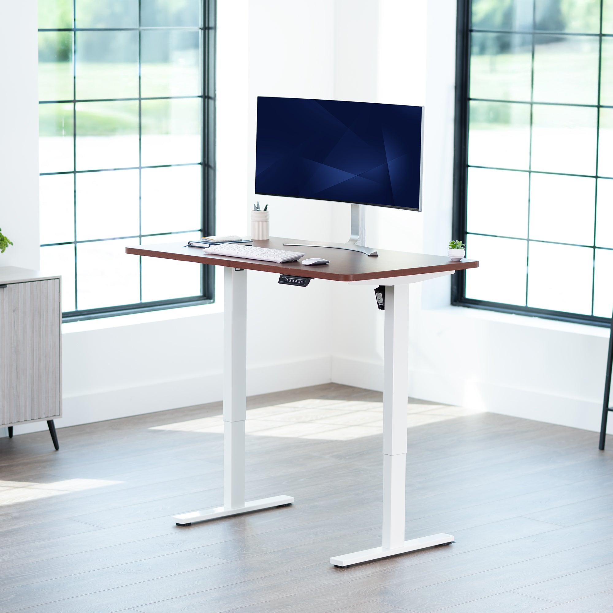 Sturdy ergonomic sit or stand active desk workstation with adjustable height using smart control panel.