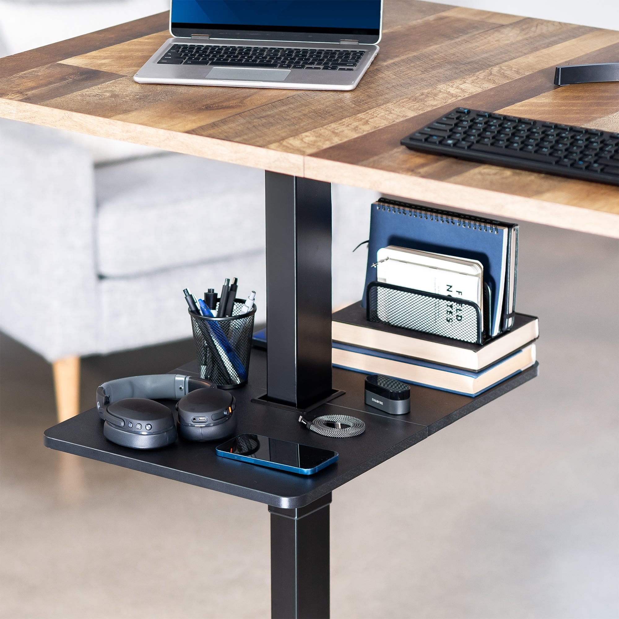 Under desk floating shelf platform that clamps onto desk leg. Provides convenient hidden storage that adjusts with your sit to stand desk.