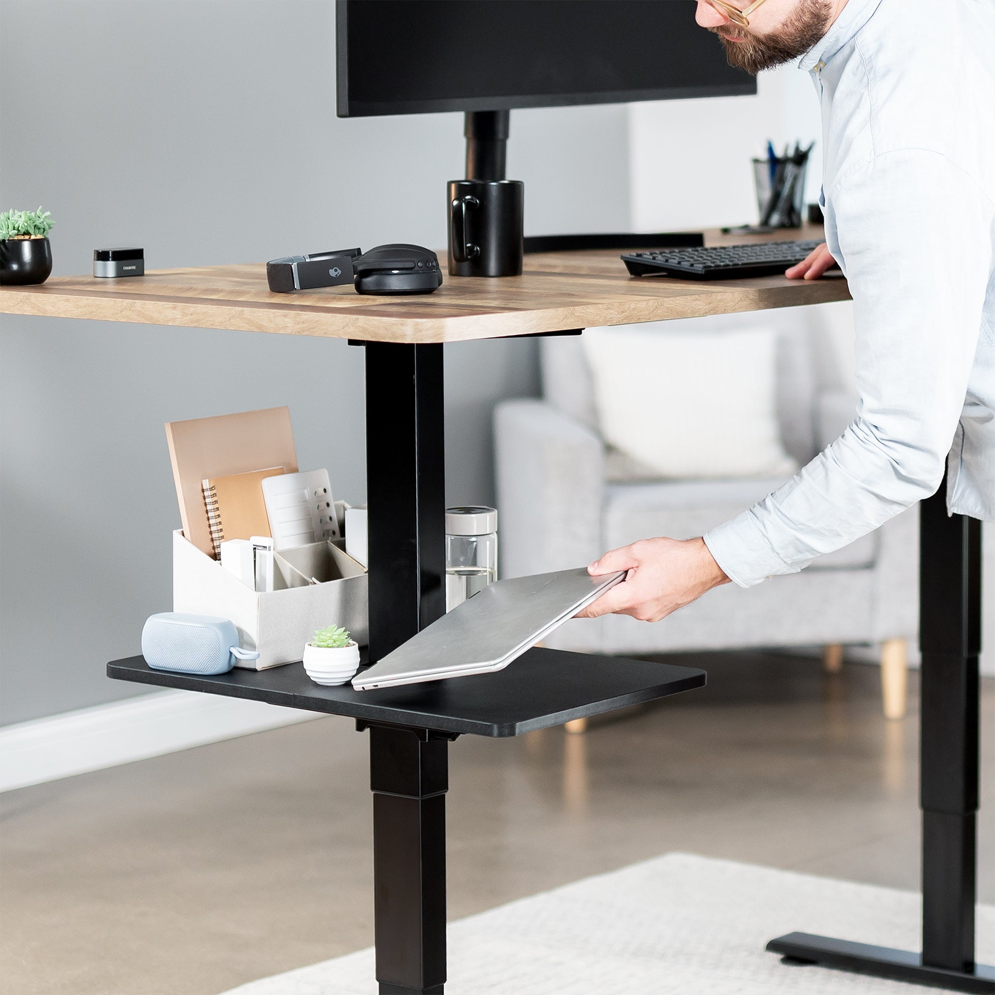 Under desk floating shelf platform that clamps onto desk leg. Provides convenient hidden storage that adjusts with your sit to stand desk.