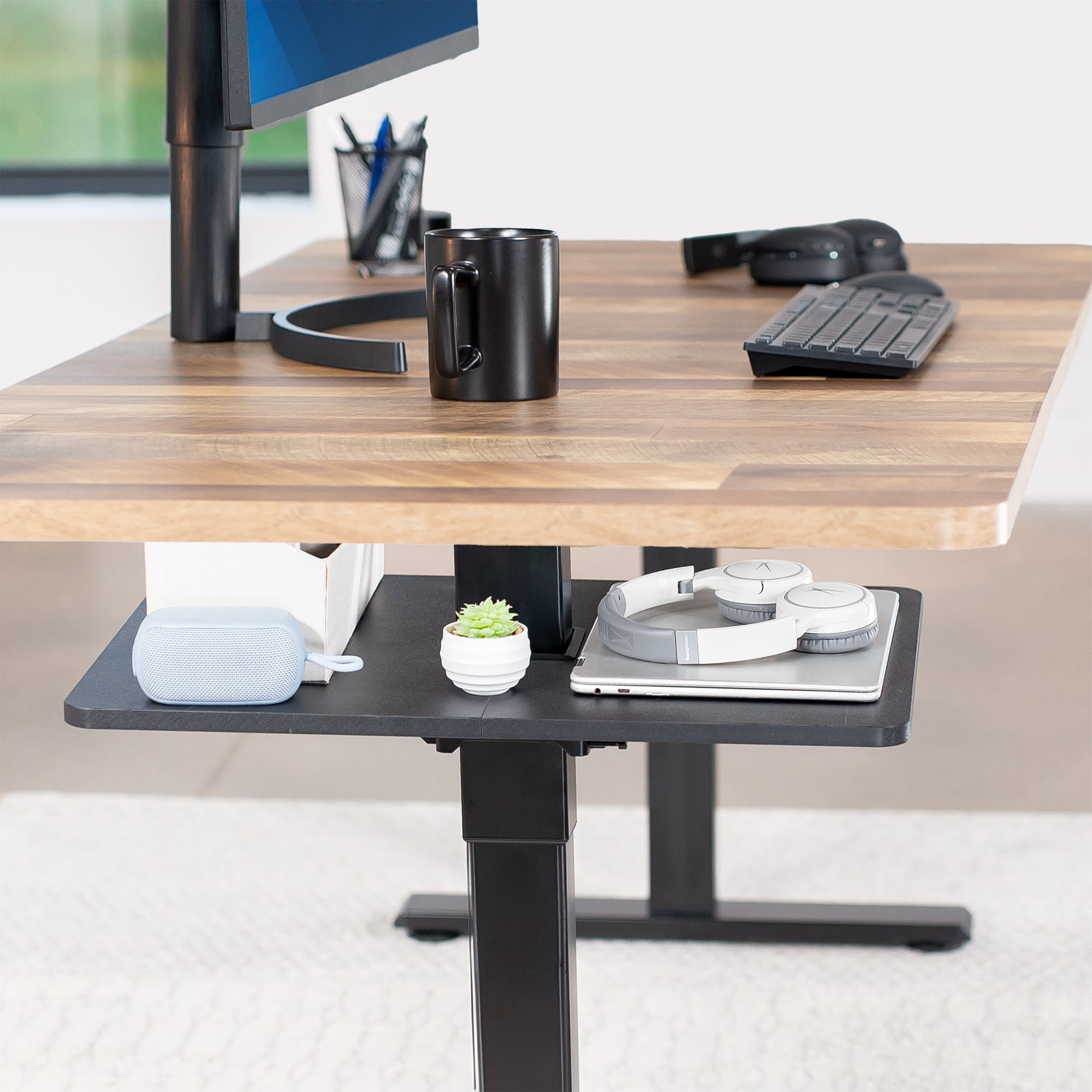 Under desk floating shelf platform that clamps onto desk leg. Provides convenient hidden storage that adjusts with your sit to stand desk.