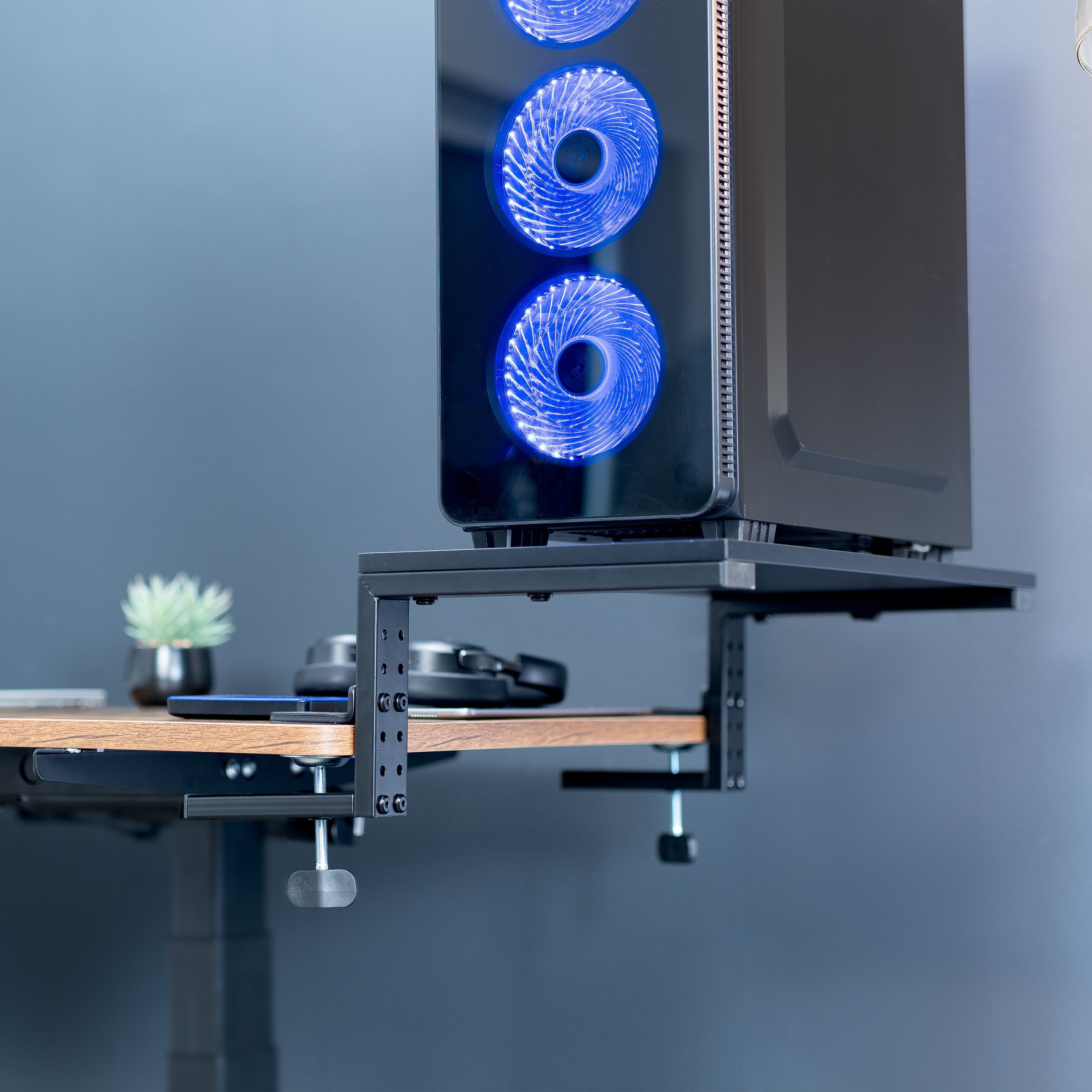 Desktop shelf holding PC tower in office