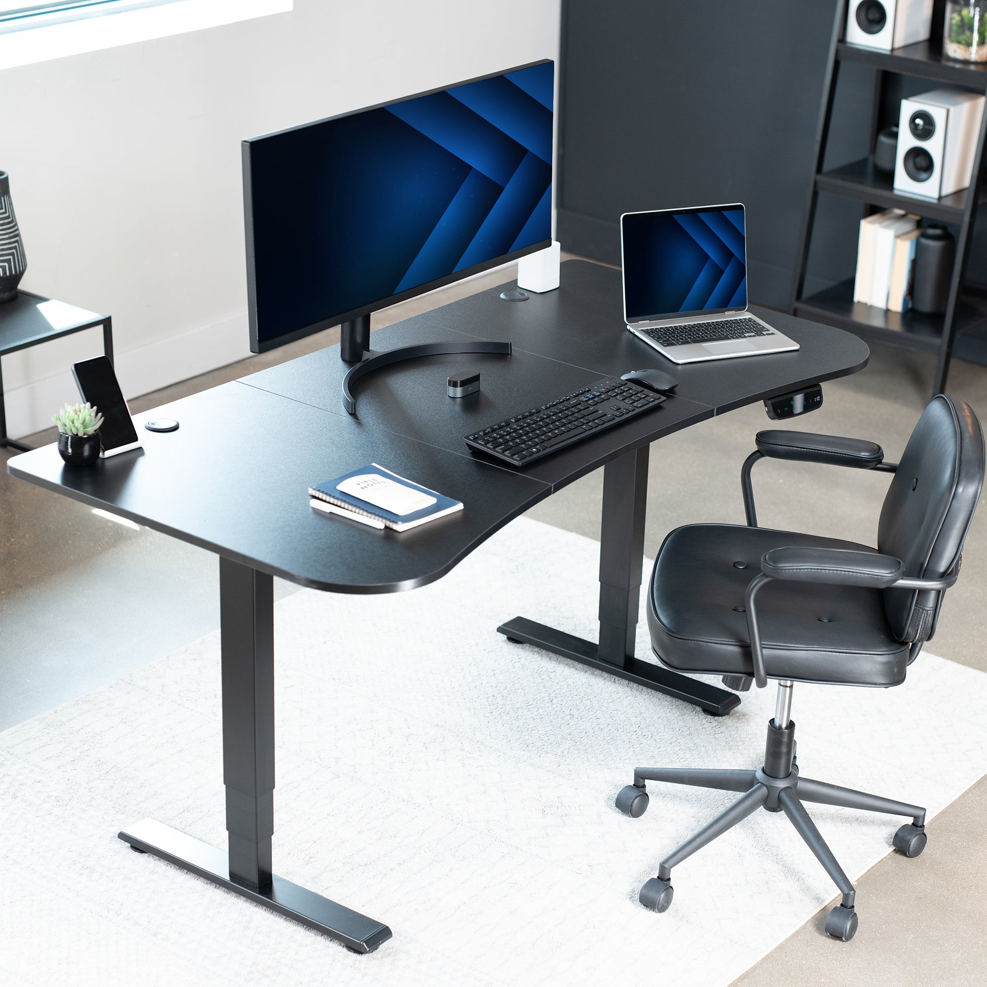 Sleek home office setup with black tabletop and black desk frame.