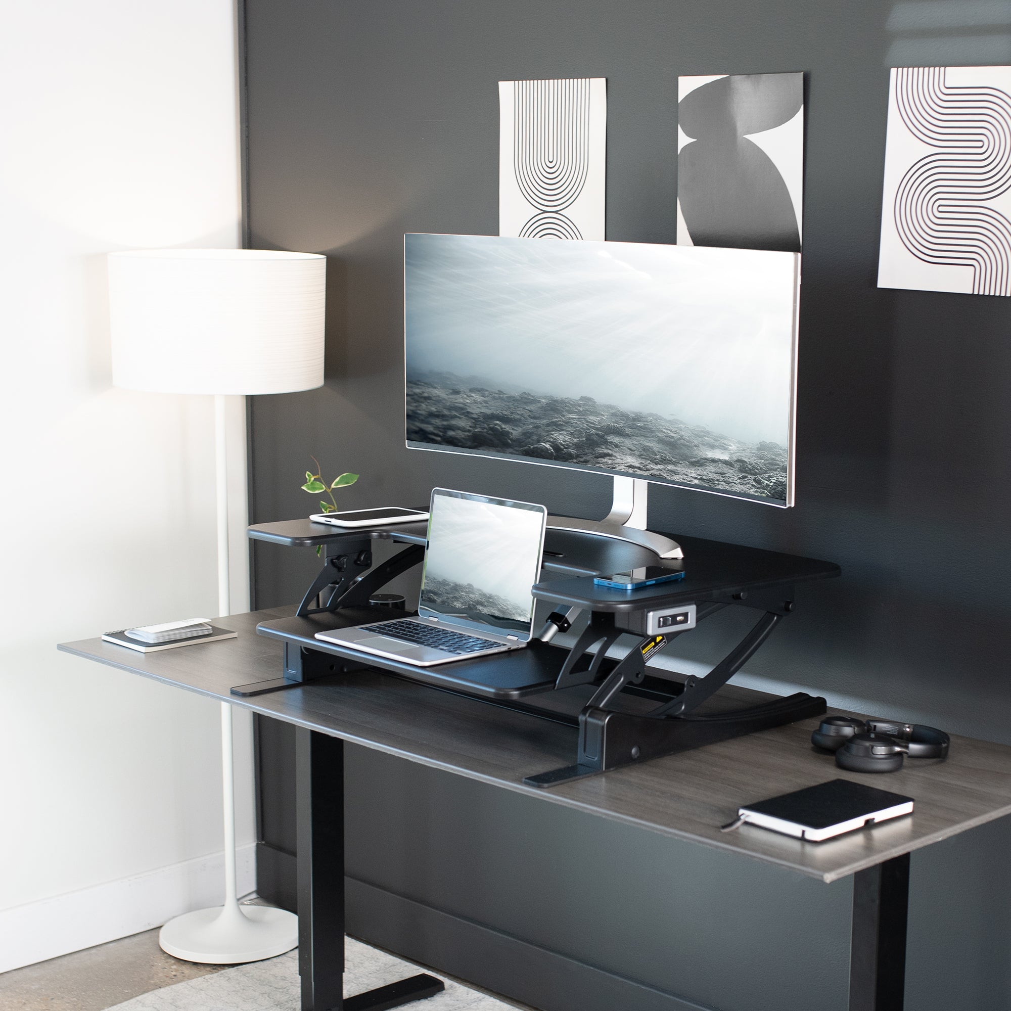 Dual-tiered, electric desk riser that sits on top of your current desk and gives you the benefit of standing up throughout the work day.