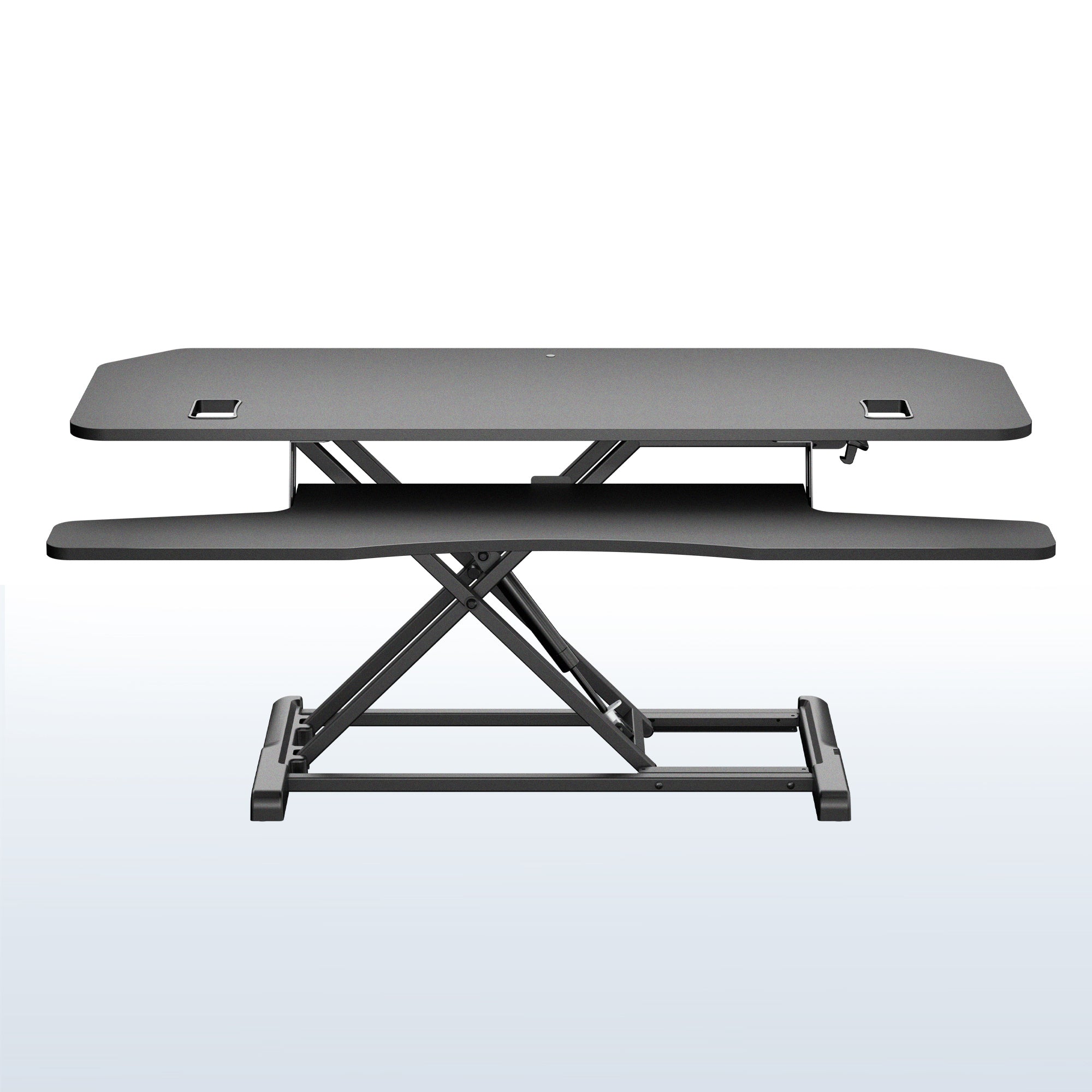 A black adjustable standing desk with a dual-tier design, featuring a raised desktop and a lower shelf supported by a robust scissor-style metal base, shown against a light white and blue gradient background.