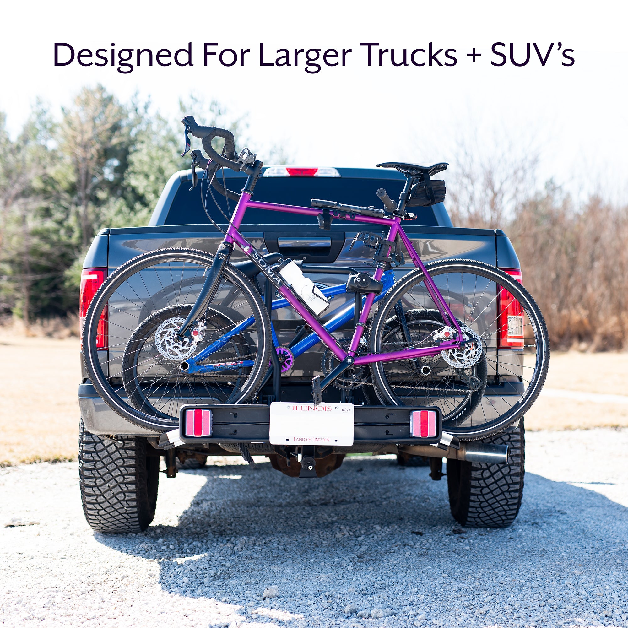 A black hitch bike rack with taillights and a license plate holder attached to the rear of a vehicle.