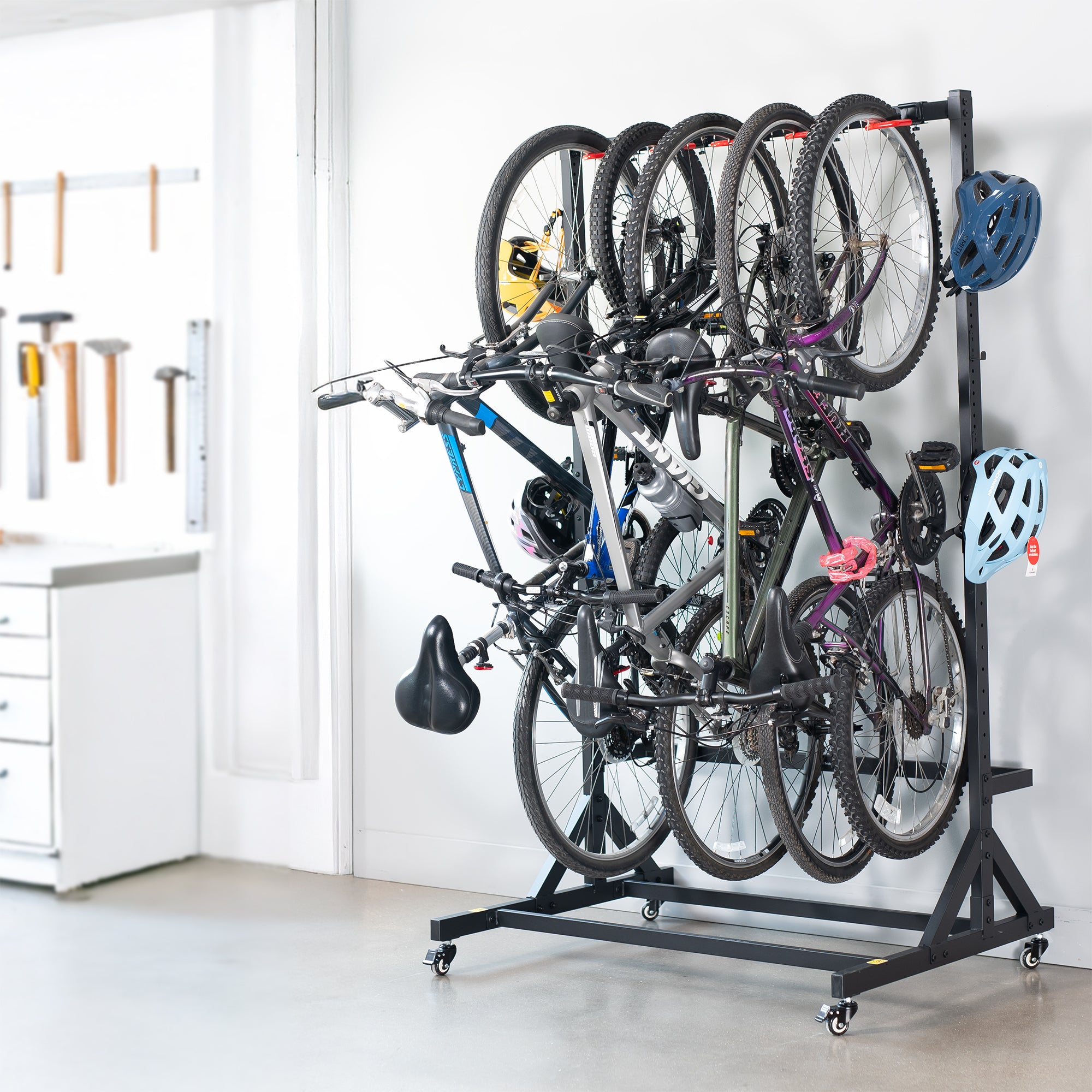 Bicycle rack holding multiple bicycles in a garage setting