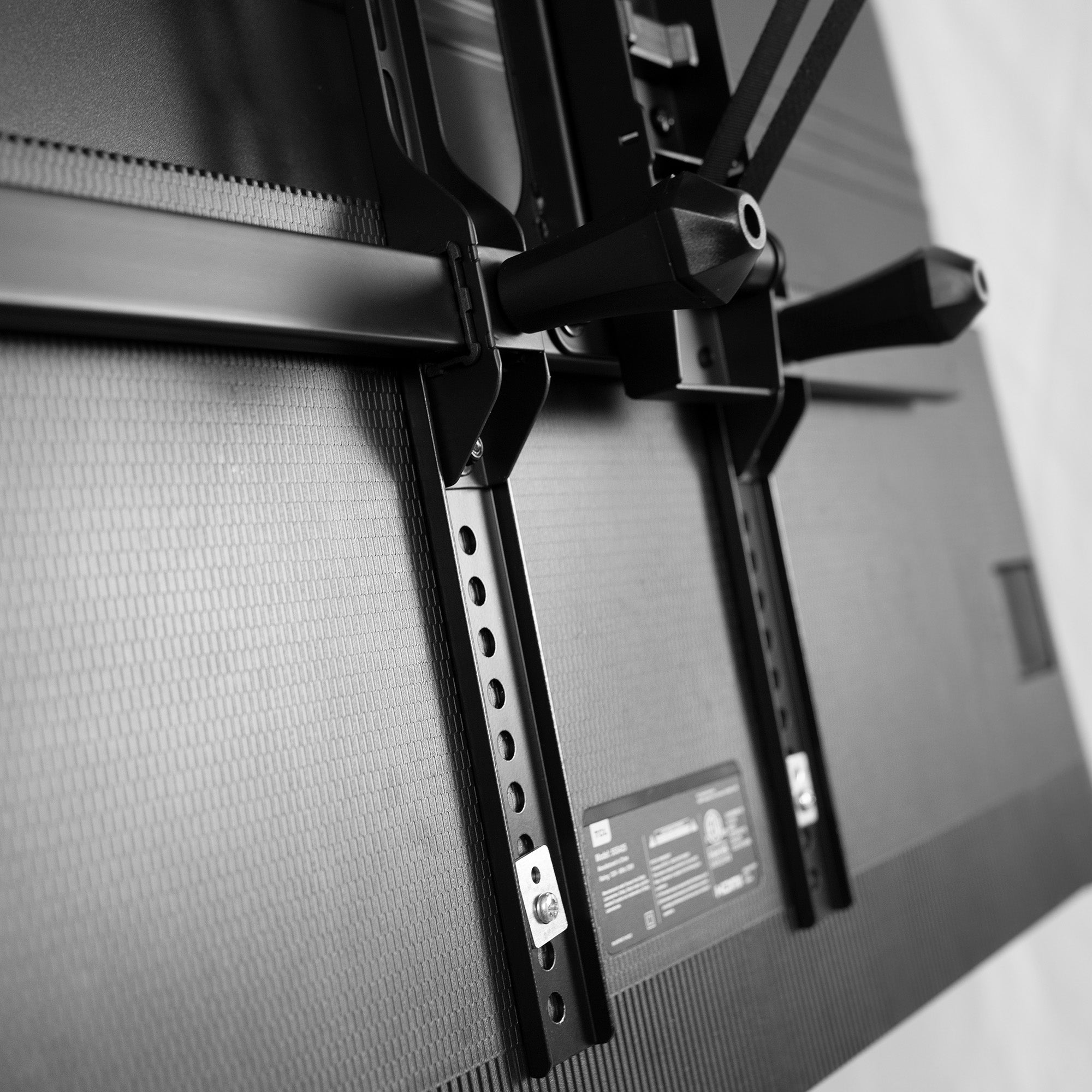 Vertical overhead VESA plate extender brackets.