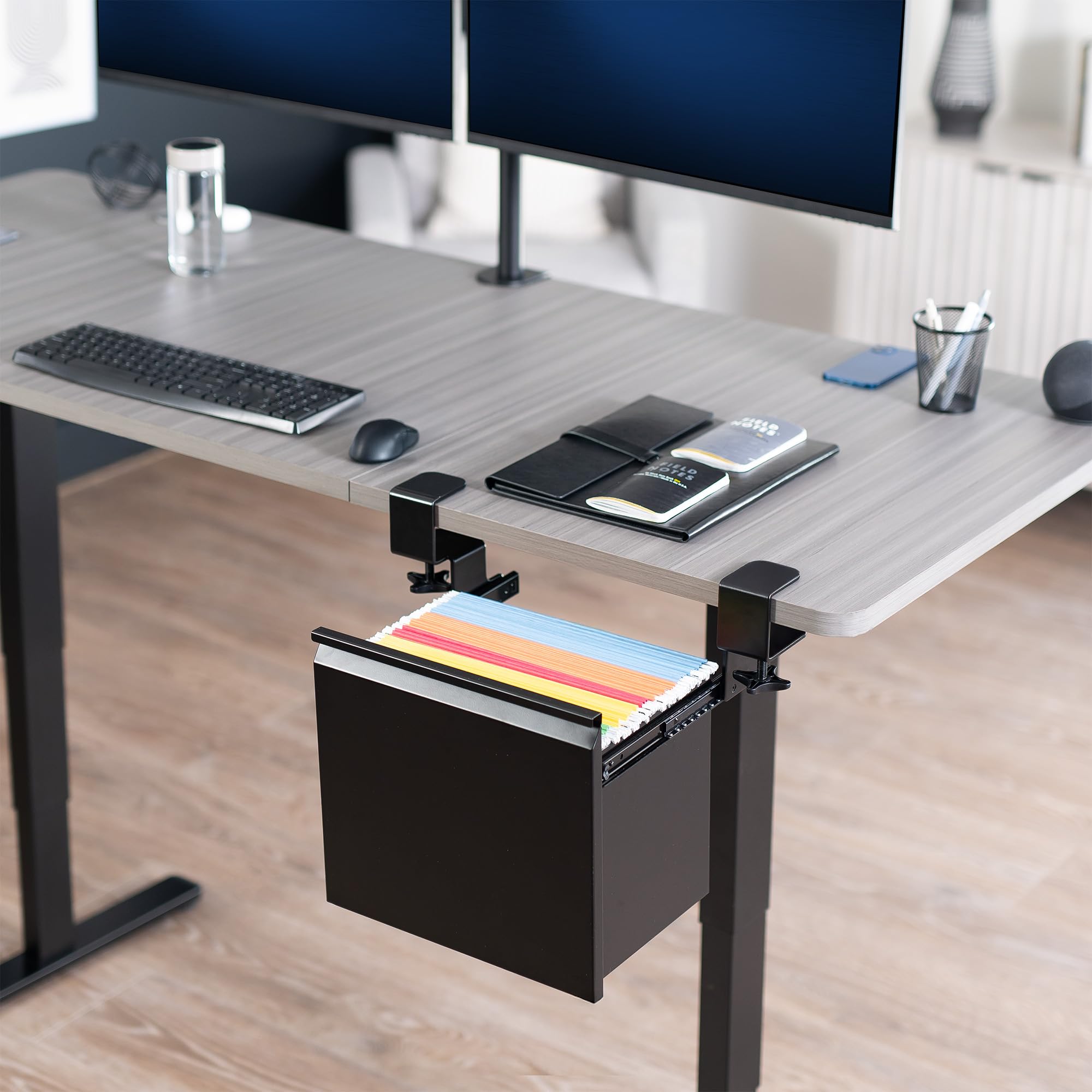 Desk with a pull-out drawer containing folders, keyboard, mouse, and office supplies.