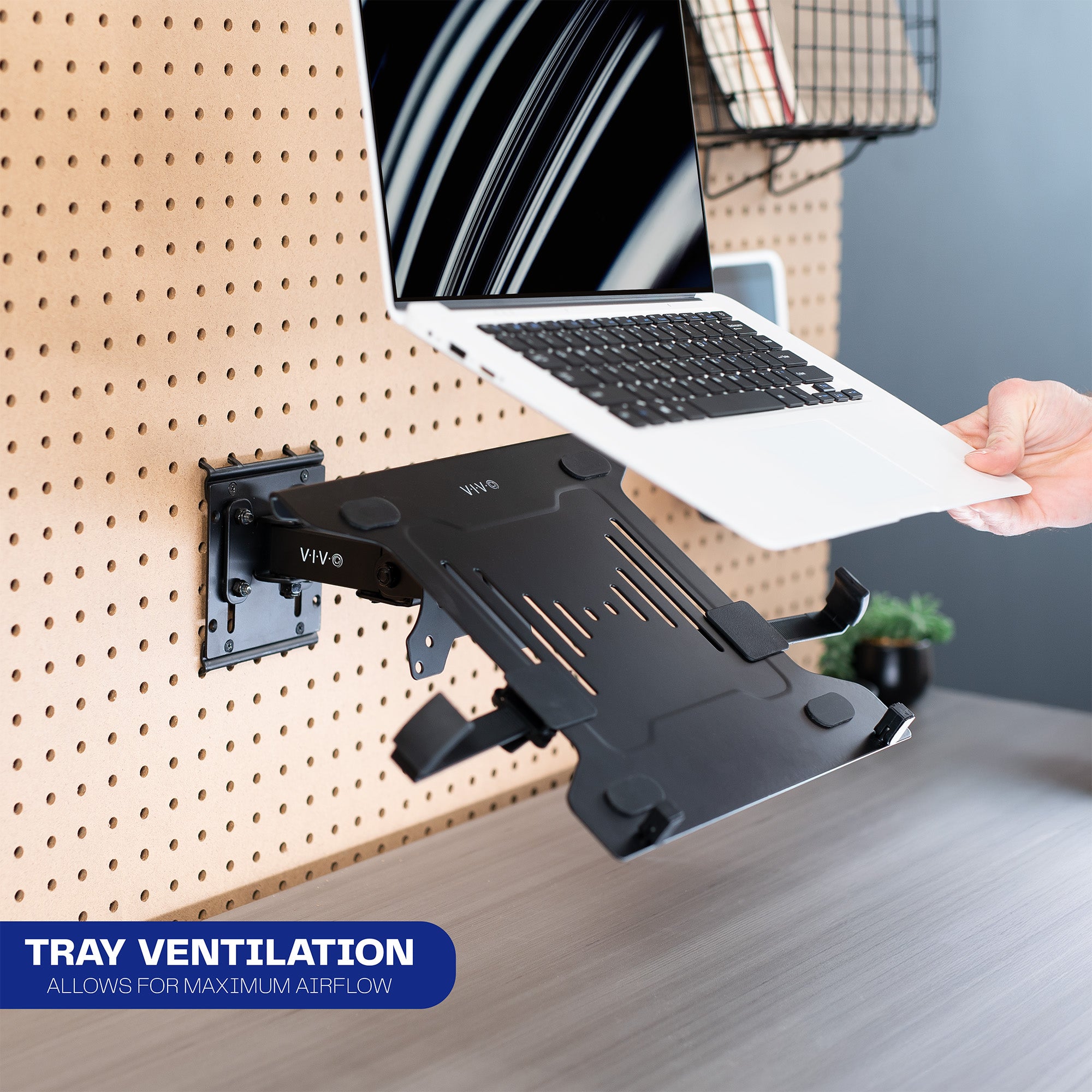 Pegboard mounted laptop tray with articulating arm. Featuring adjustable holder clamps and tray ventilation.