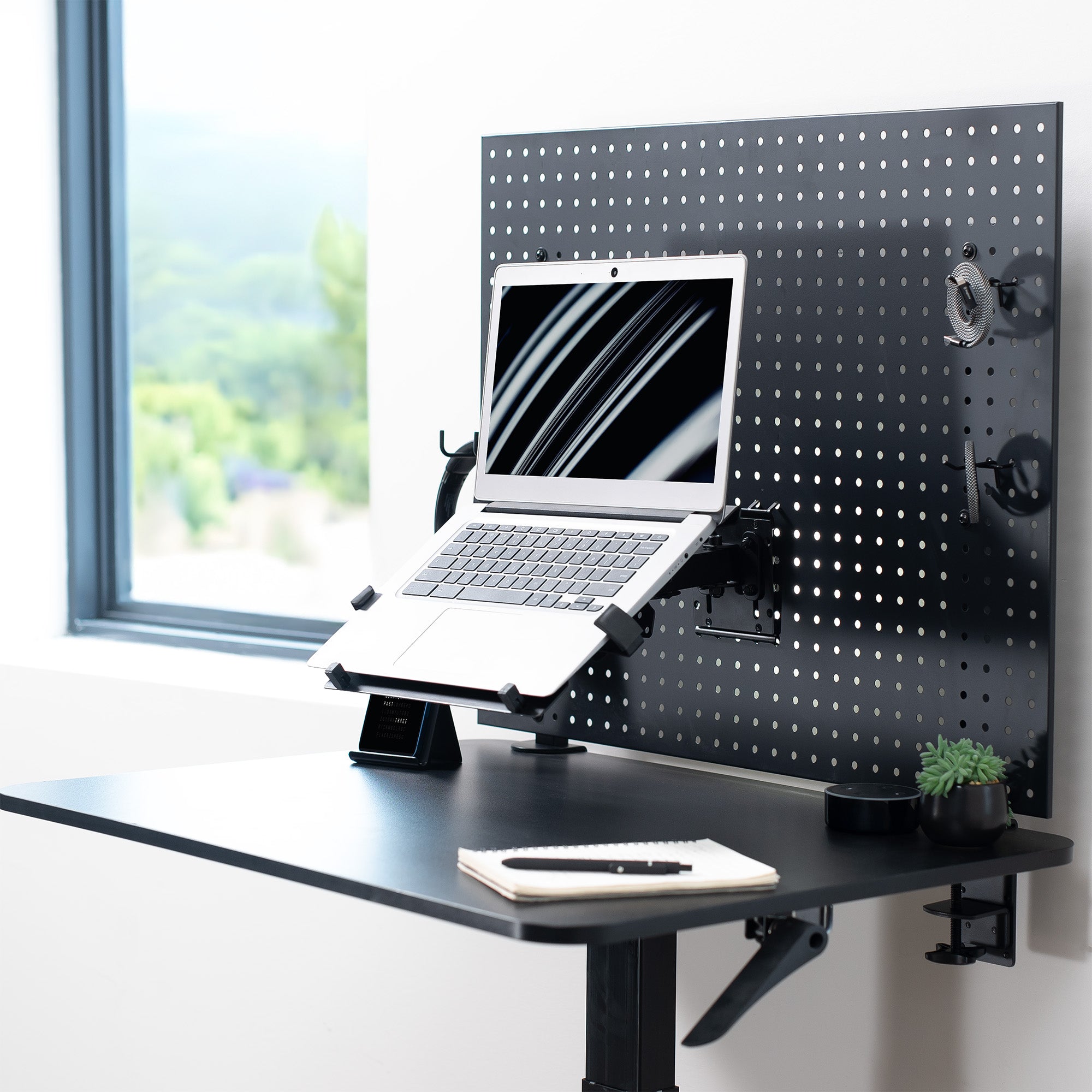 Pegboard mounted laptop tray with articulating arm. Featuring adjustable holder clamps and tray ventilation.