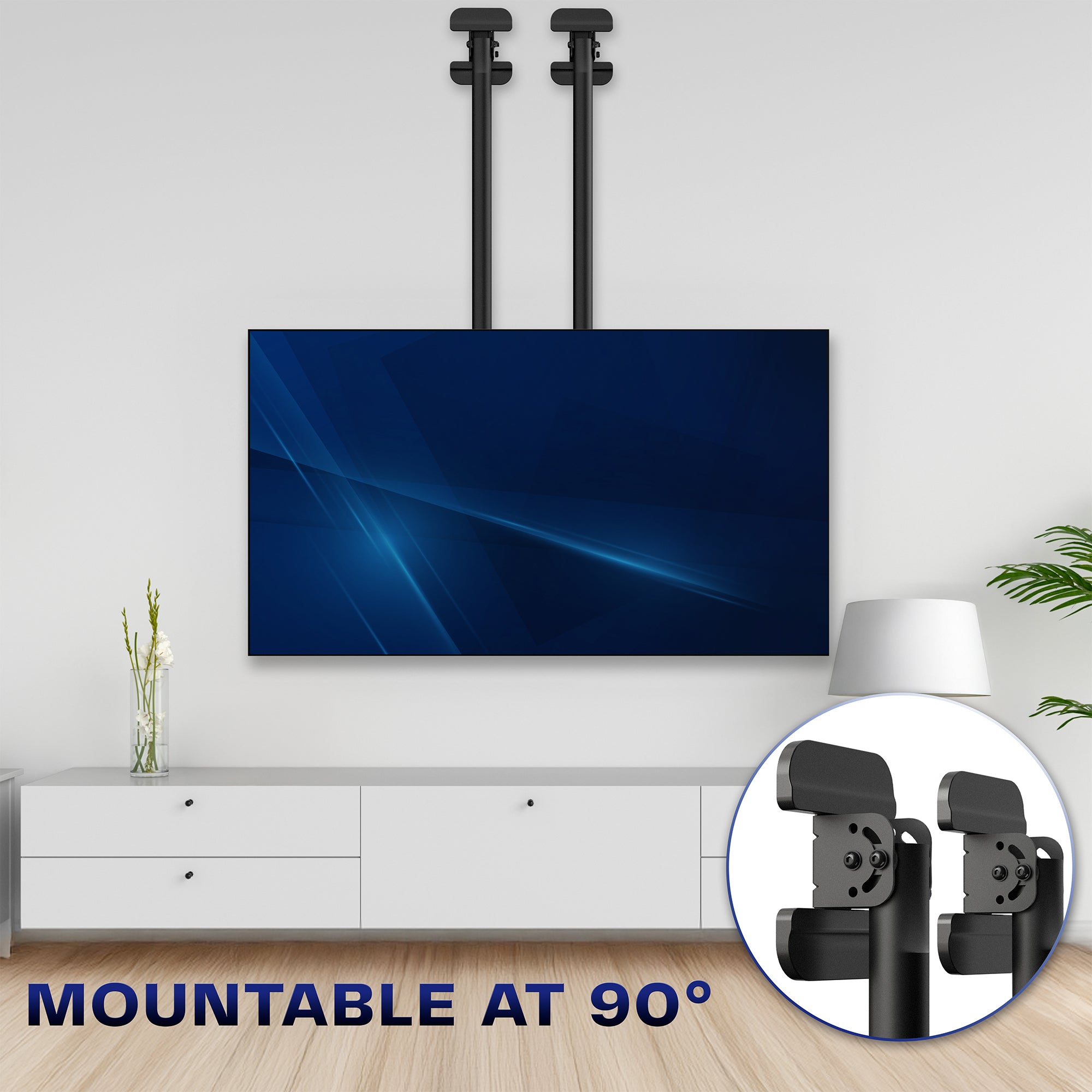TV mounted on a wall with a close-up of the mount at a 90 degree angle, in a room with a white cabinet and plant.