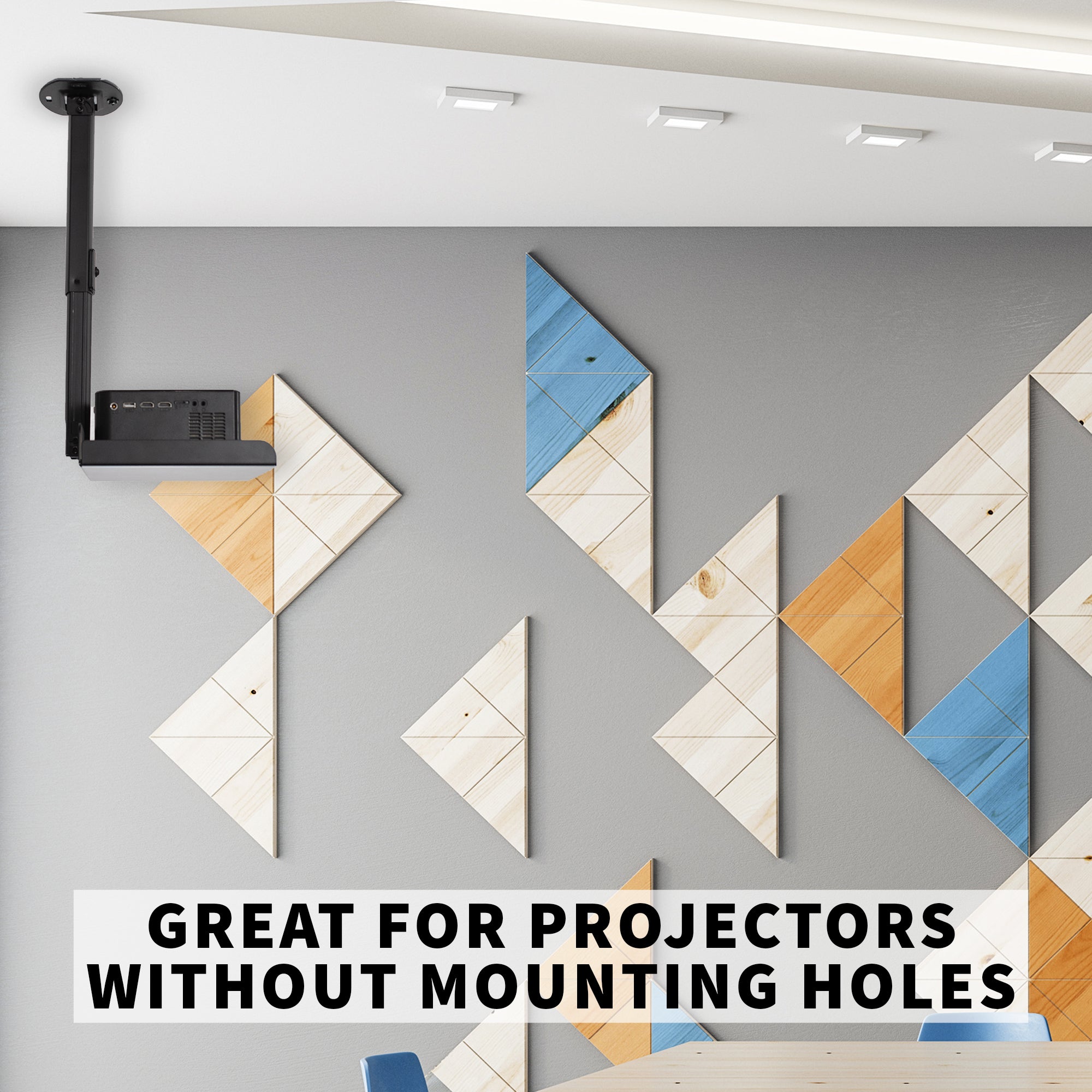 Projector on a ceiling mounted projector tray with geometric wall art in the background