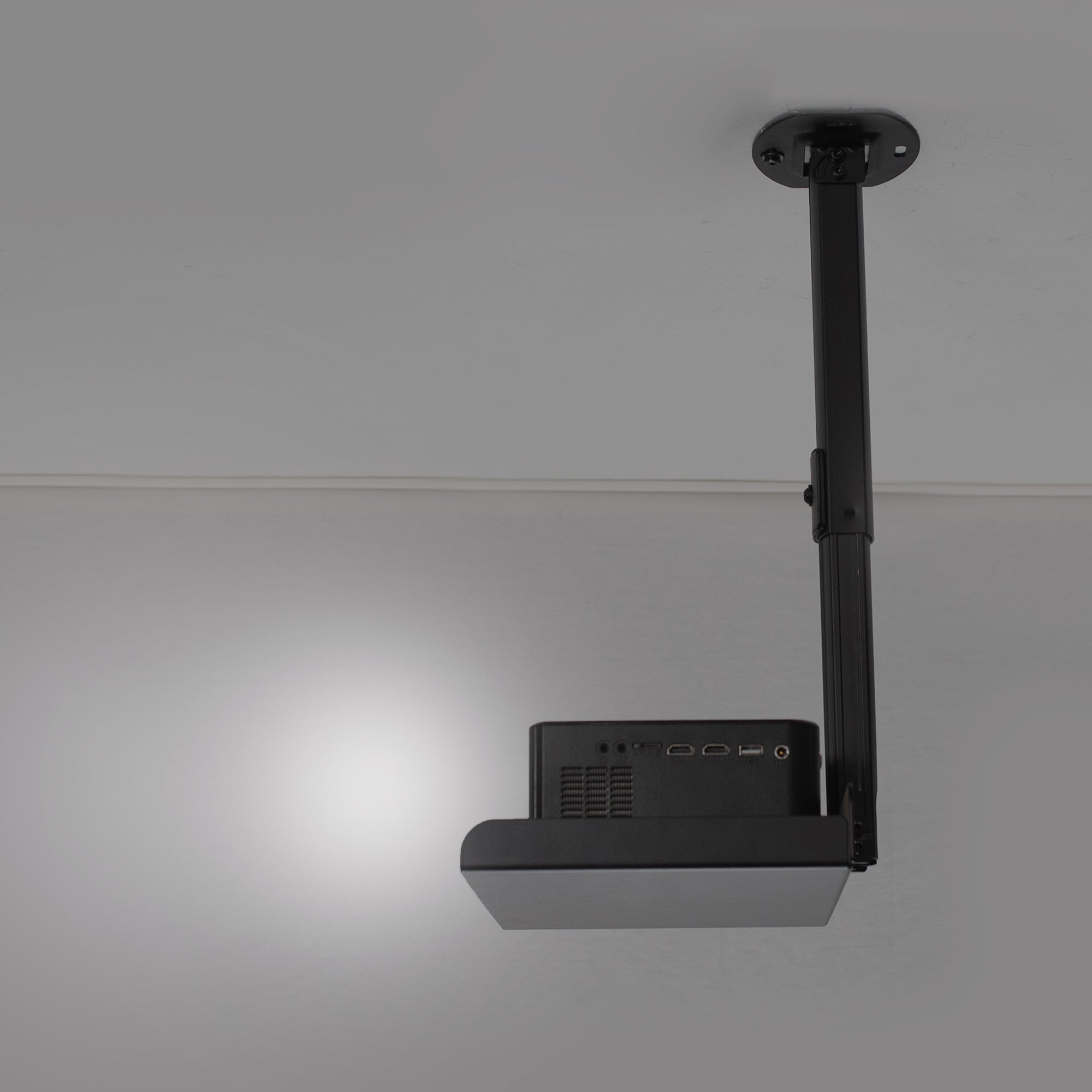 Black projector mount on a gray ceiling
