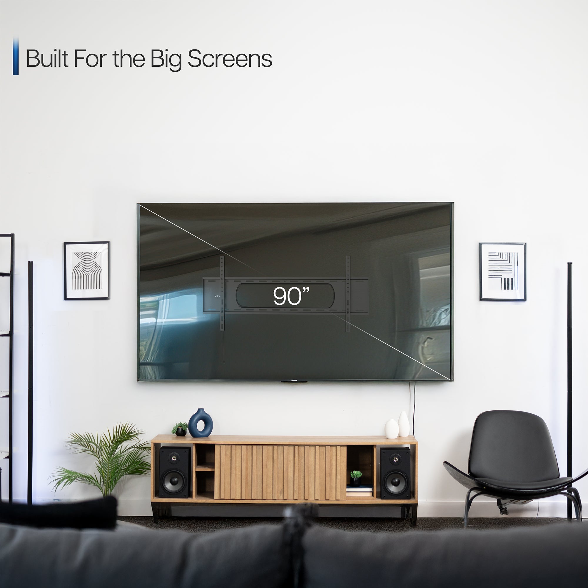 A black tilting wall mount for TVs with a visible label showing the largest screen size compatibility.