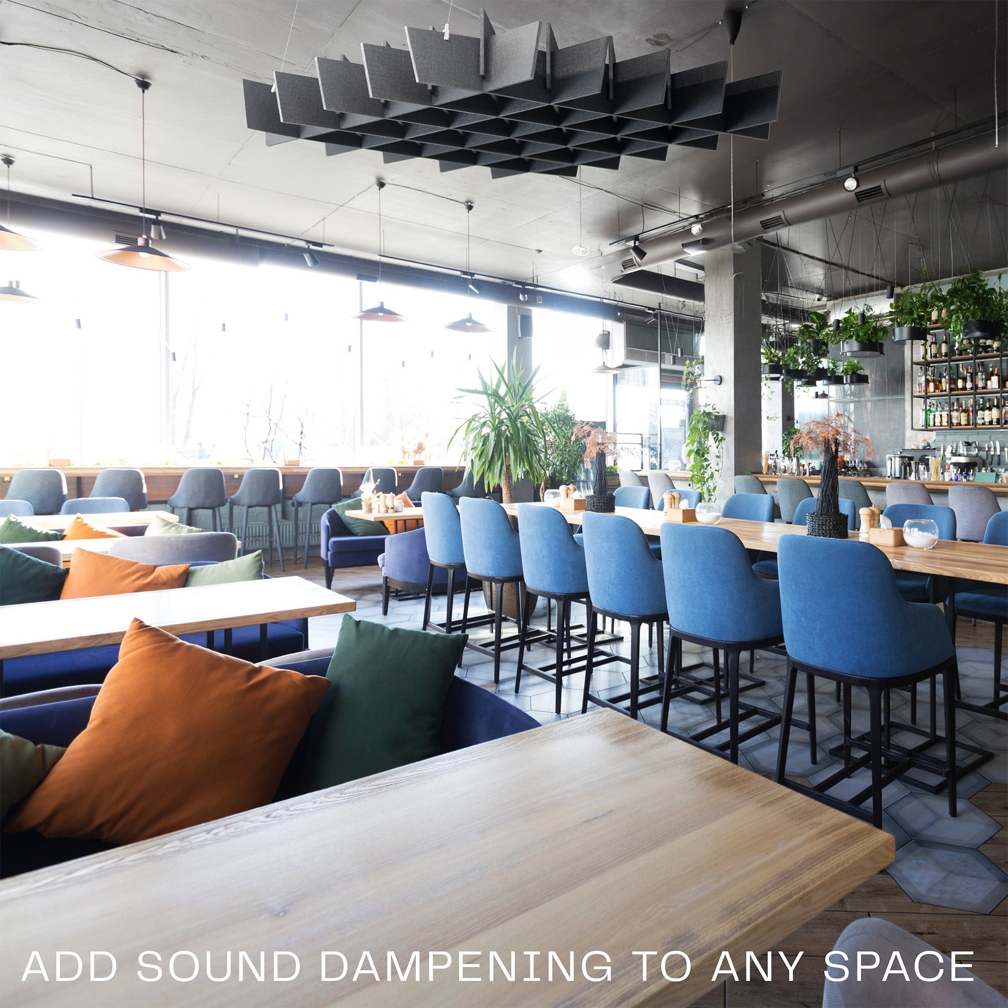 A black acoustic dual-layer ceiling waffle panel with a geometric pattern, mounted on a ceiling in a lounge/restaurant setting.