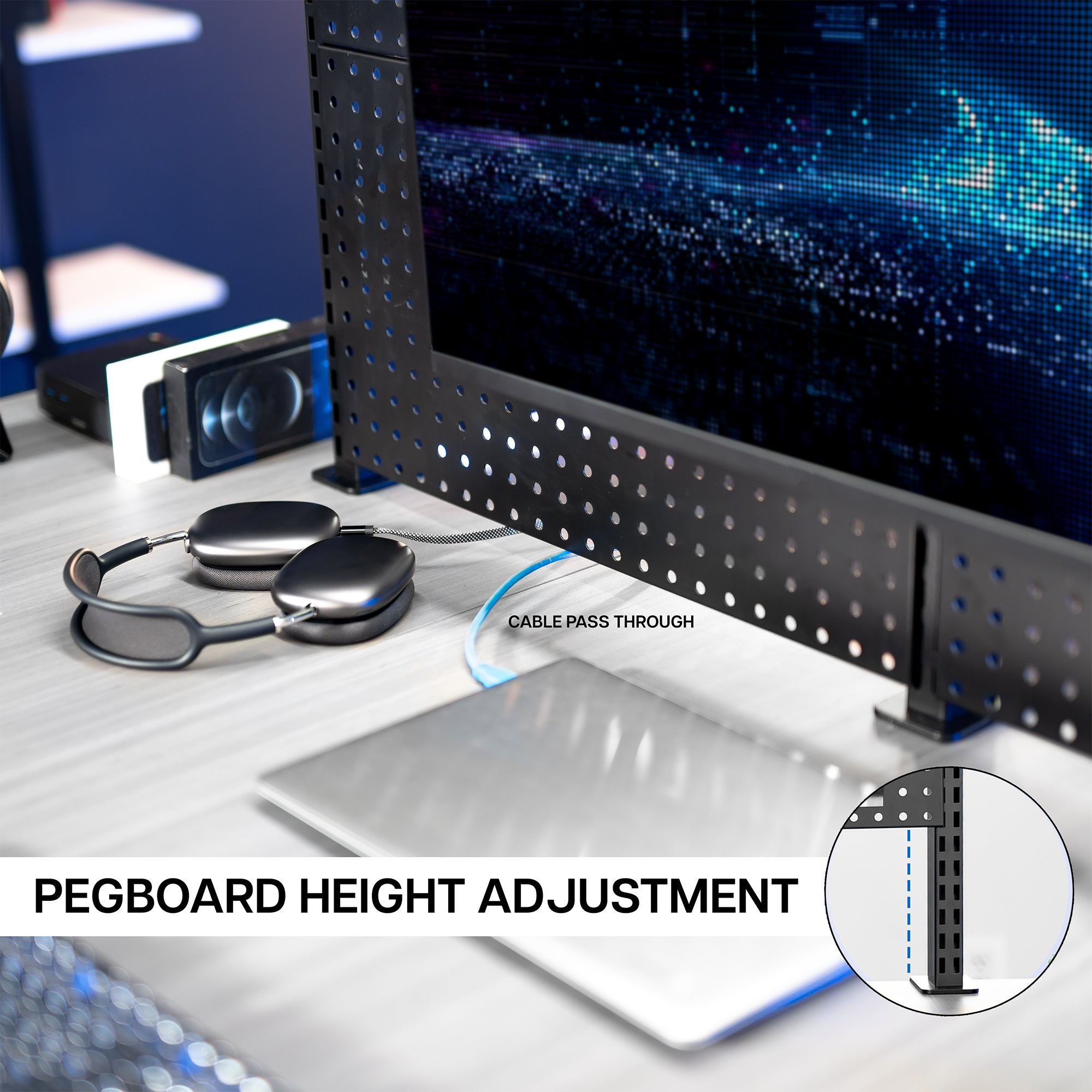 A black clamp-on pegboard monitor mount with a shelf, holding a flat-screen monitor with a laptop on the desk with height adjustment feature highlighted.