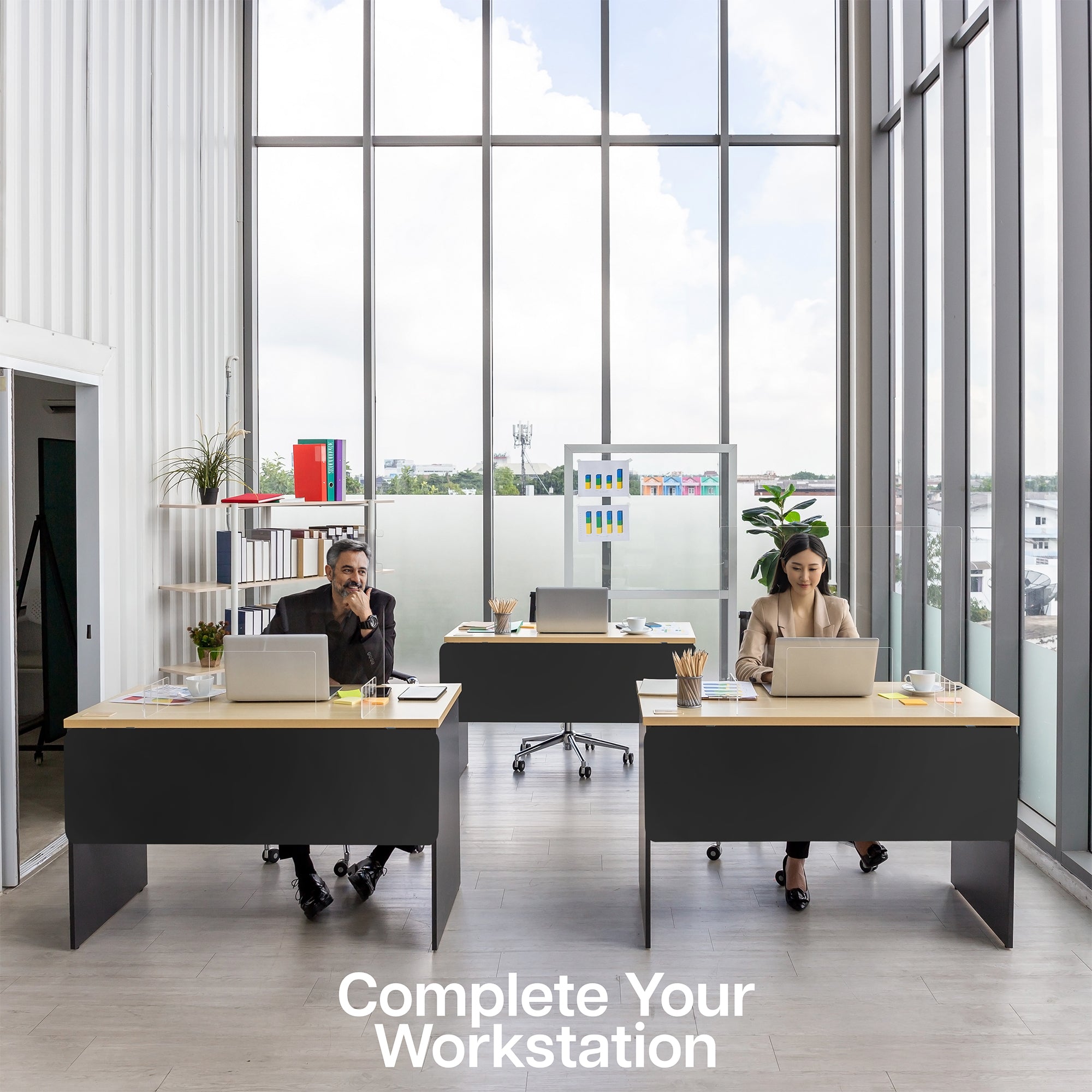 A black laminate modesty panel in a modern office workstation with a man and a woman each at a desk.