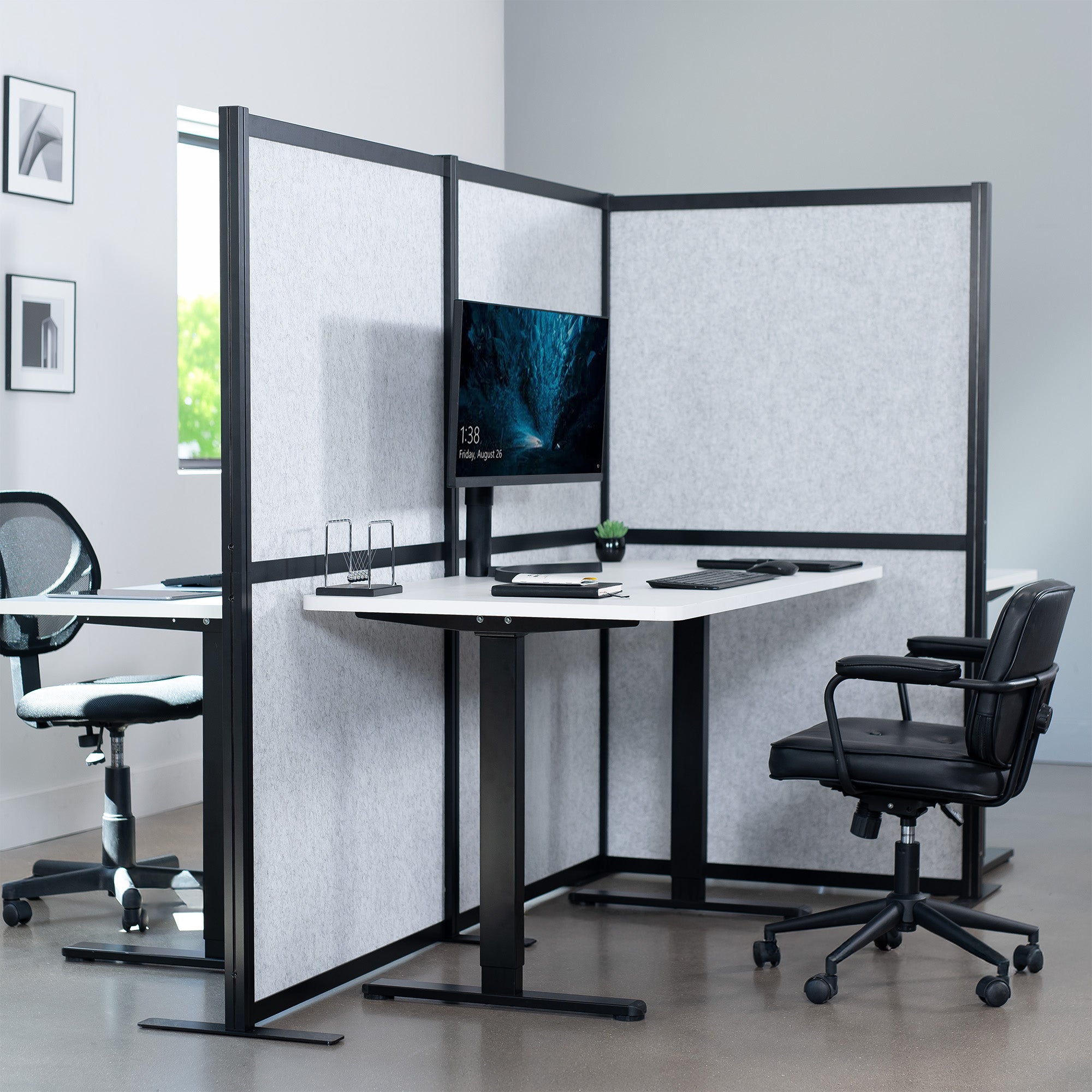 Modern office setup with partitioned workstations, desks, and chairs.