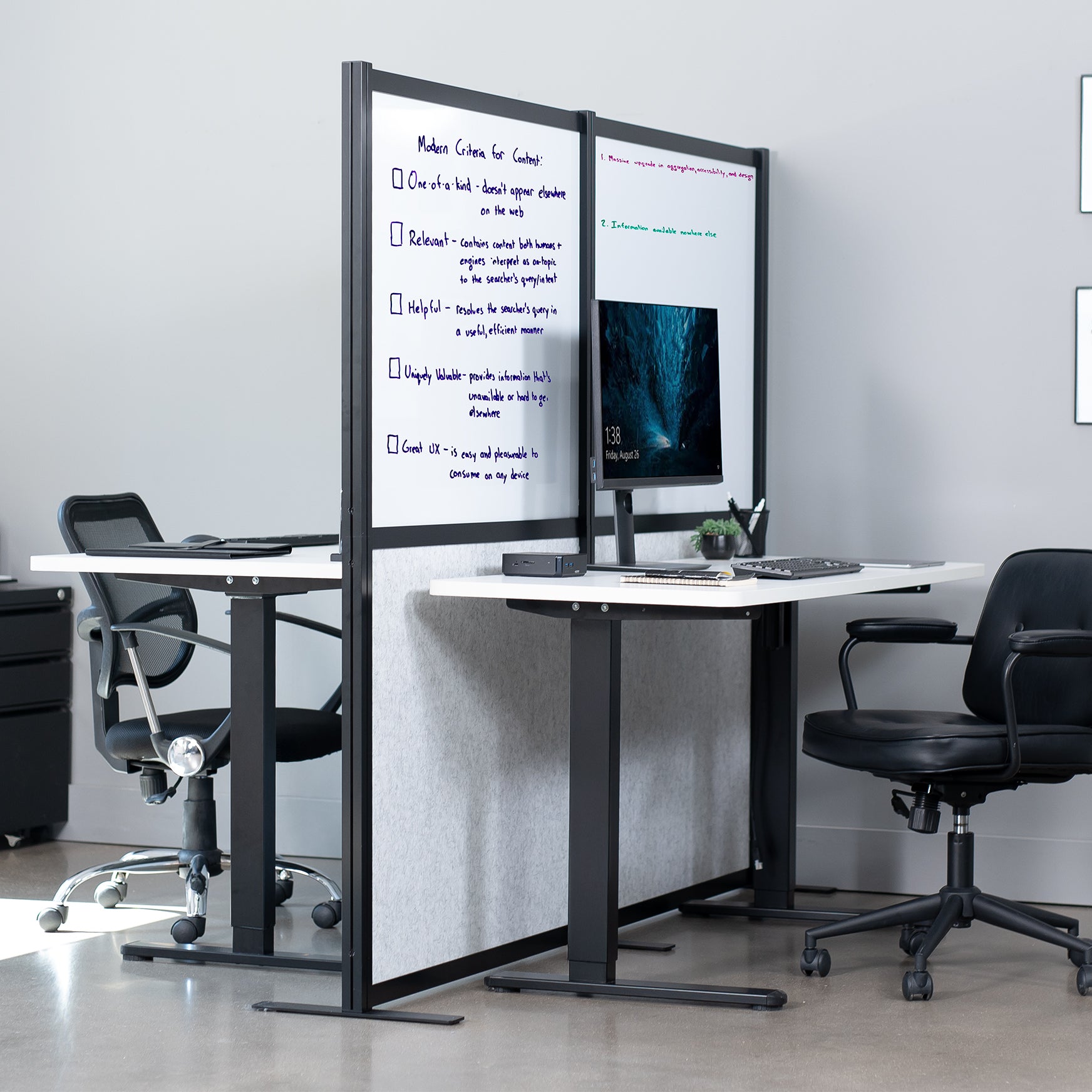 Modern office setup with sit to stand desks and whiteboard partition / divider separating.