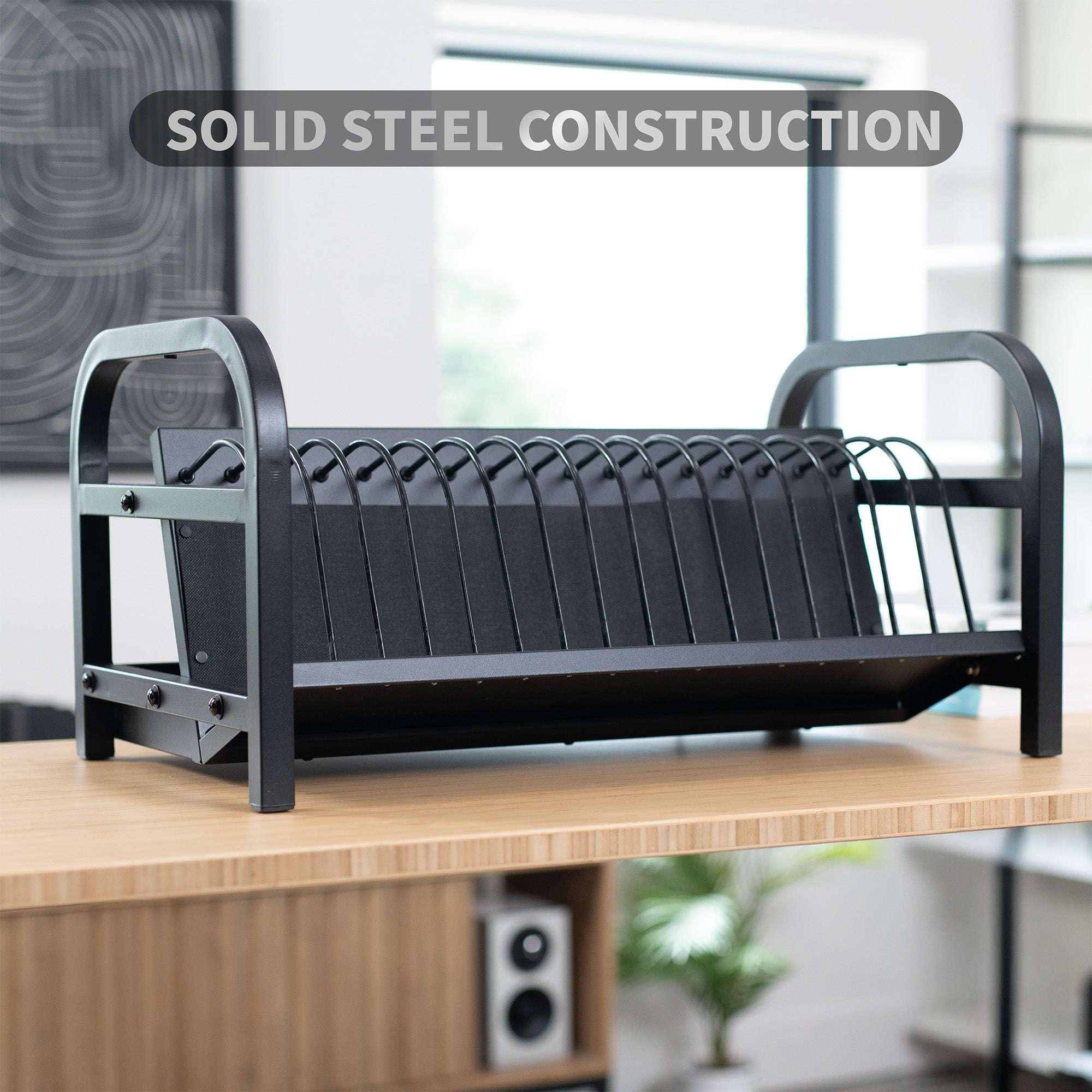 Black charging rack on a wooden surface with text overlay.