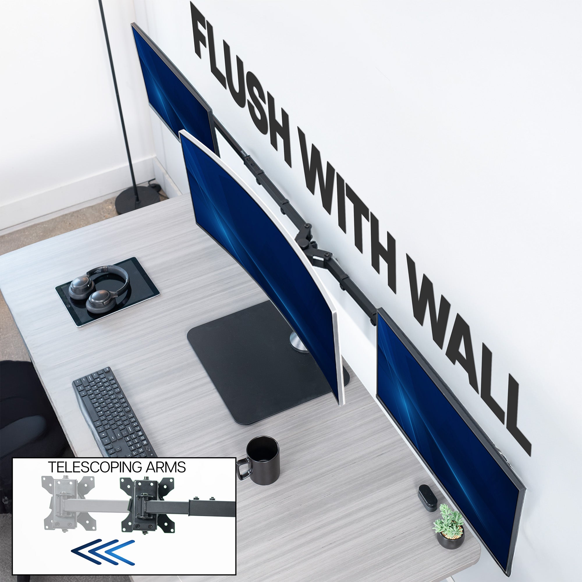 Wall-mounted computer setup with telescoping arms and desk accessories.