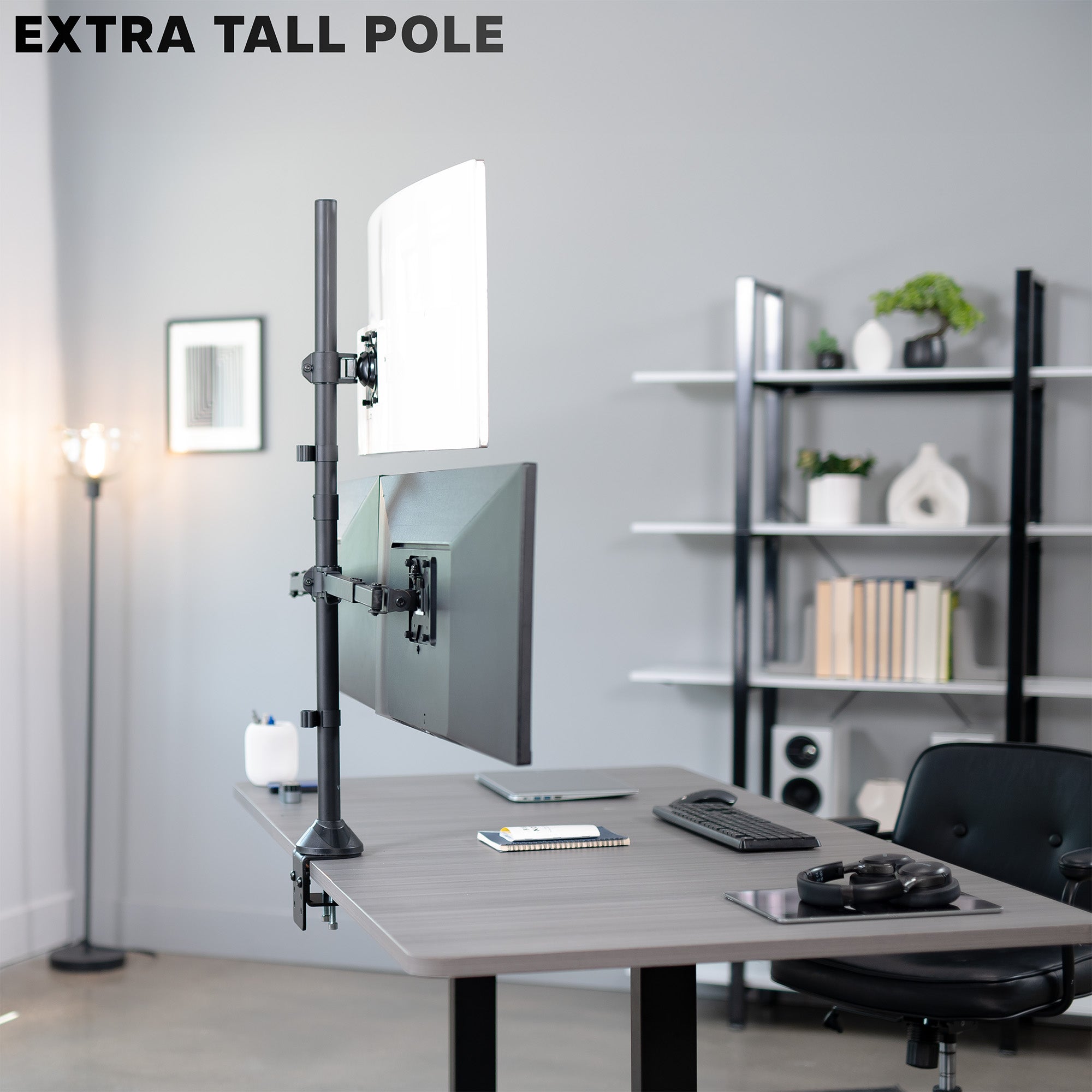 Modern office setup with a desk, computer monitor, and extra tall pole.