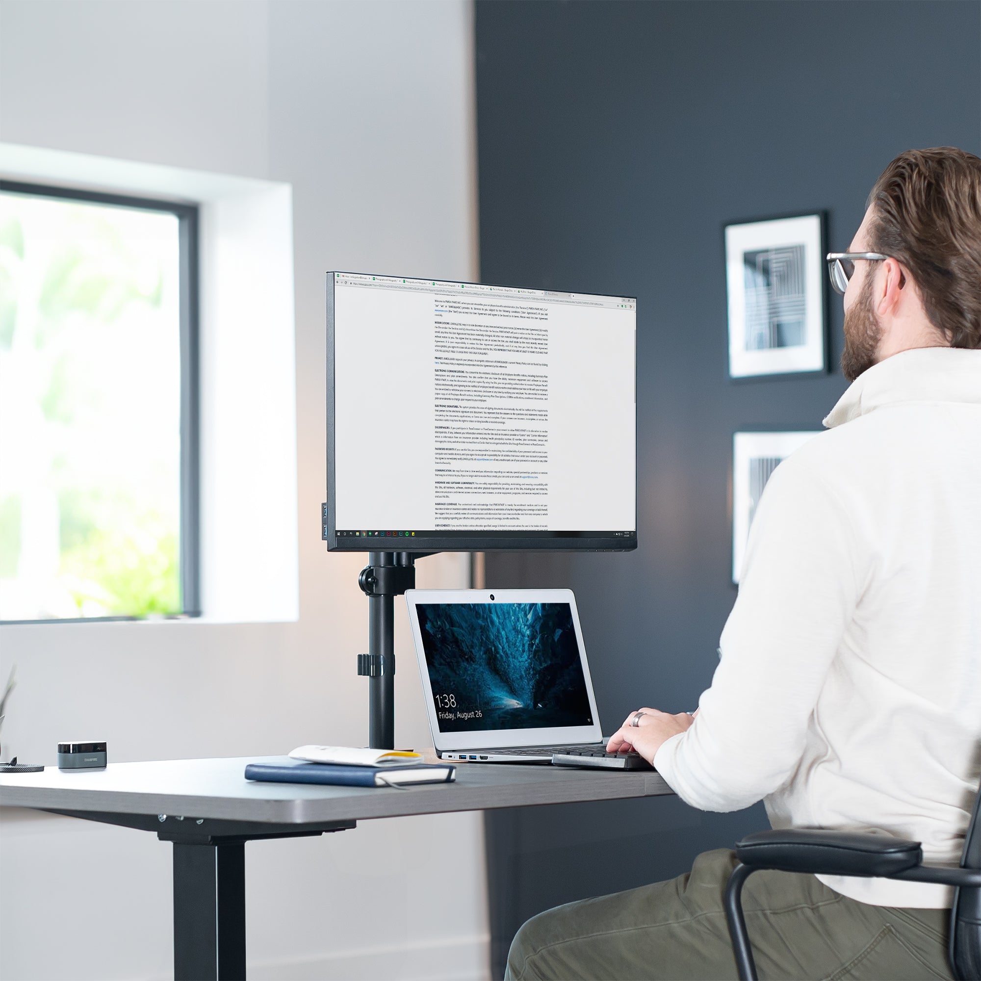 Pneumatic single monitor mount in modern office space