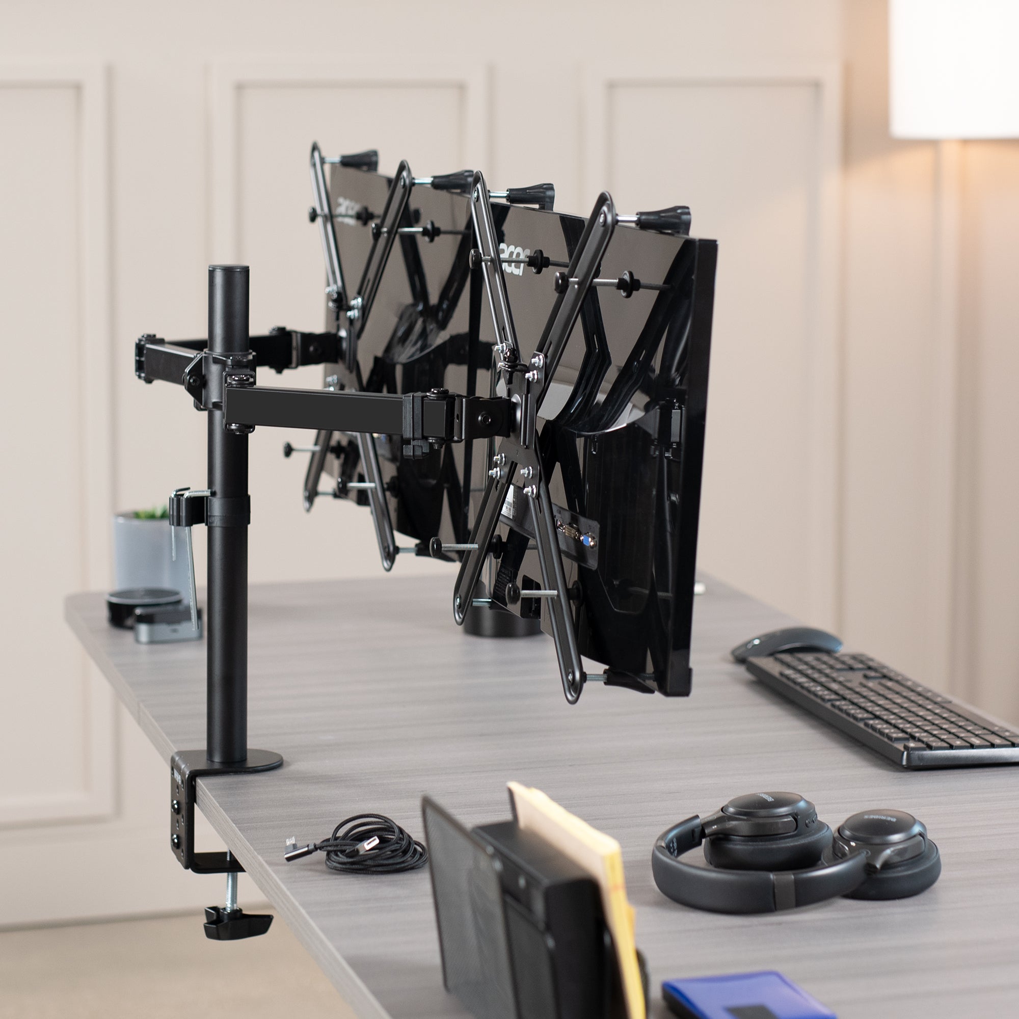 Dual Monitor Desk Mount with VESA Adapter Bracket mounted on desk in office setting.
