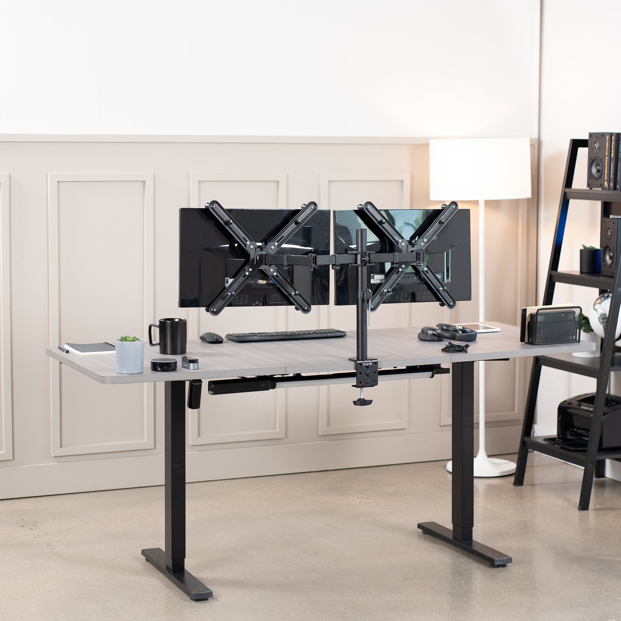 Dual Monitor Desk Mount with VESA Adapter Bracket mounted on desk in office setting.