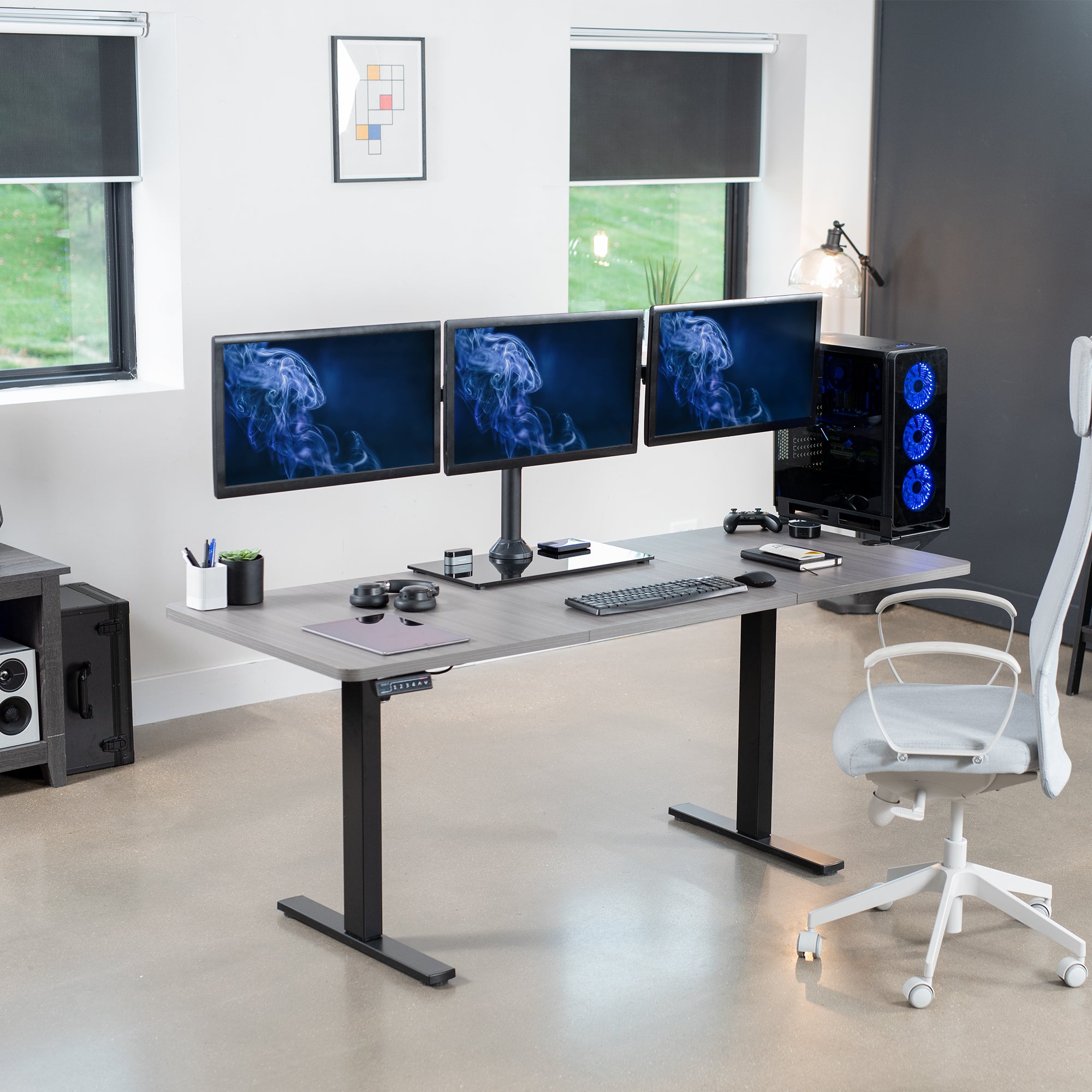 Triple Monitor Desk Stand on desk in office setting.