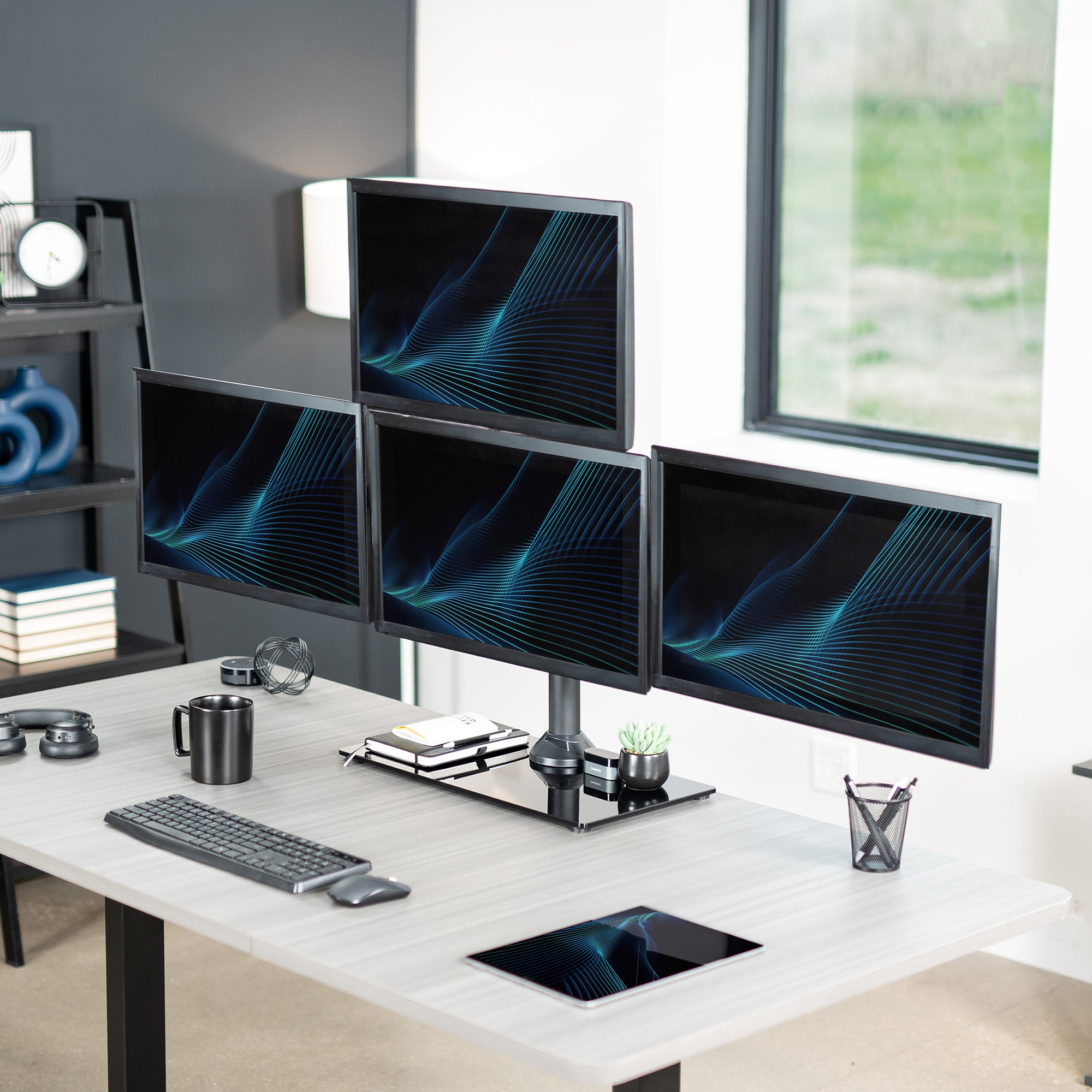 Sturdy height adjustable quad monitor desk stand.