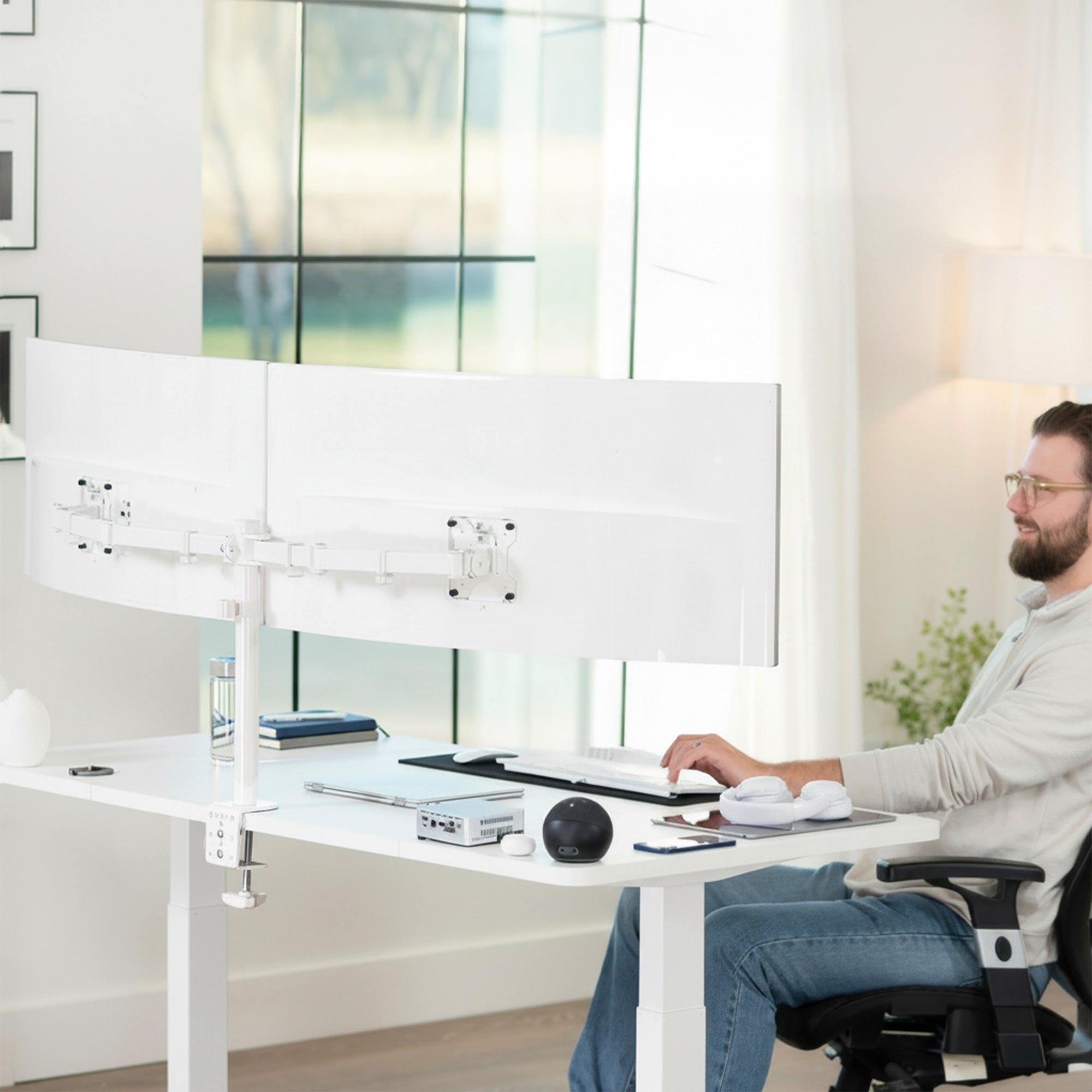 Sturdy adjustable dual monitor ergonomic desk mount for office workstation.