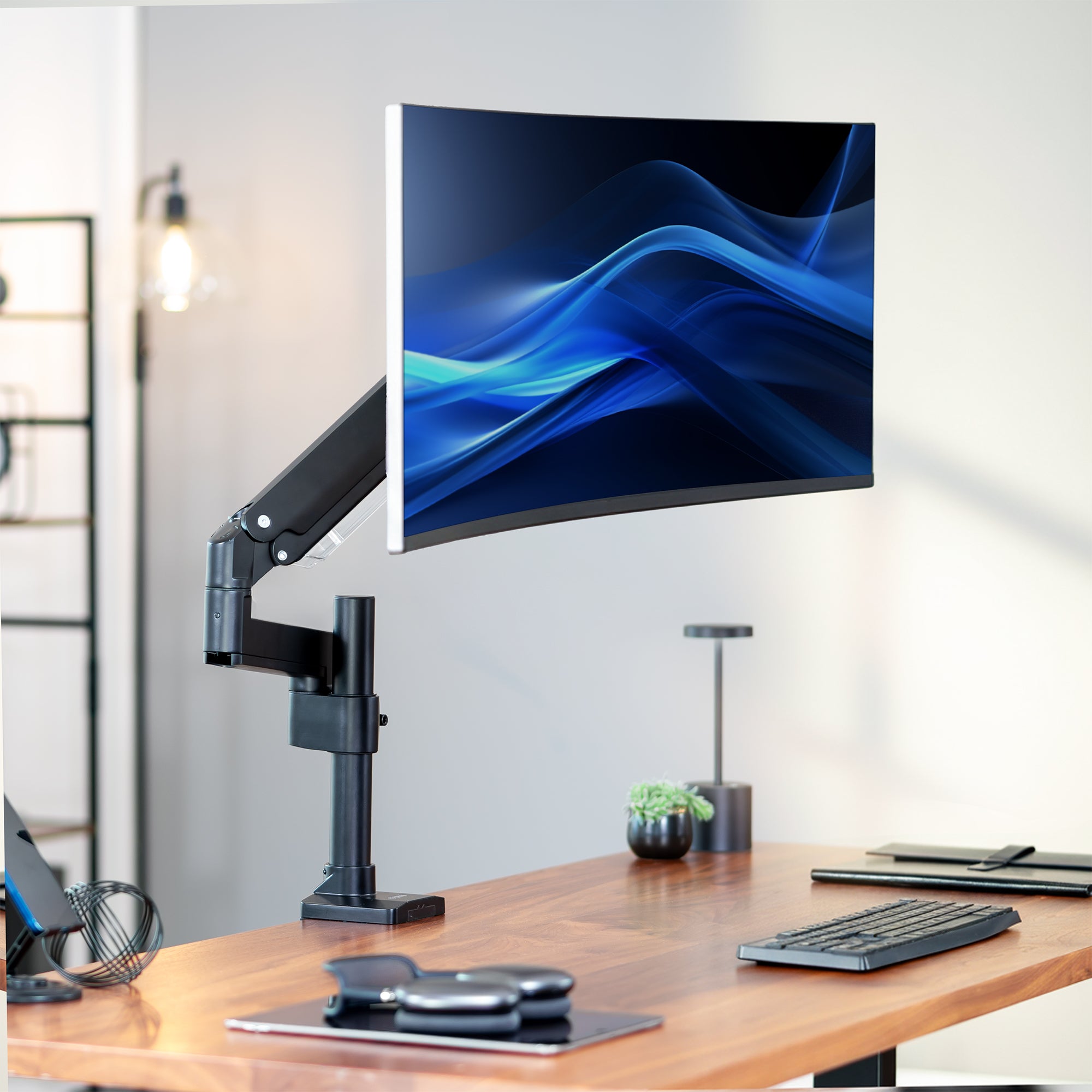Pneumatic Arm Single Monitor Desk Mount on desk in office space