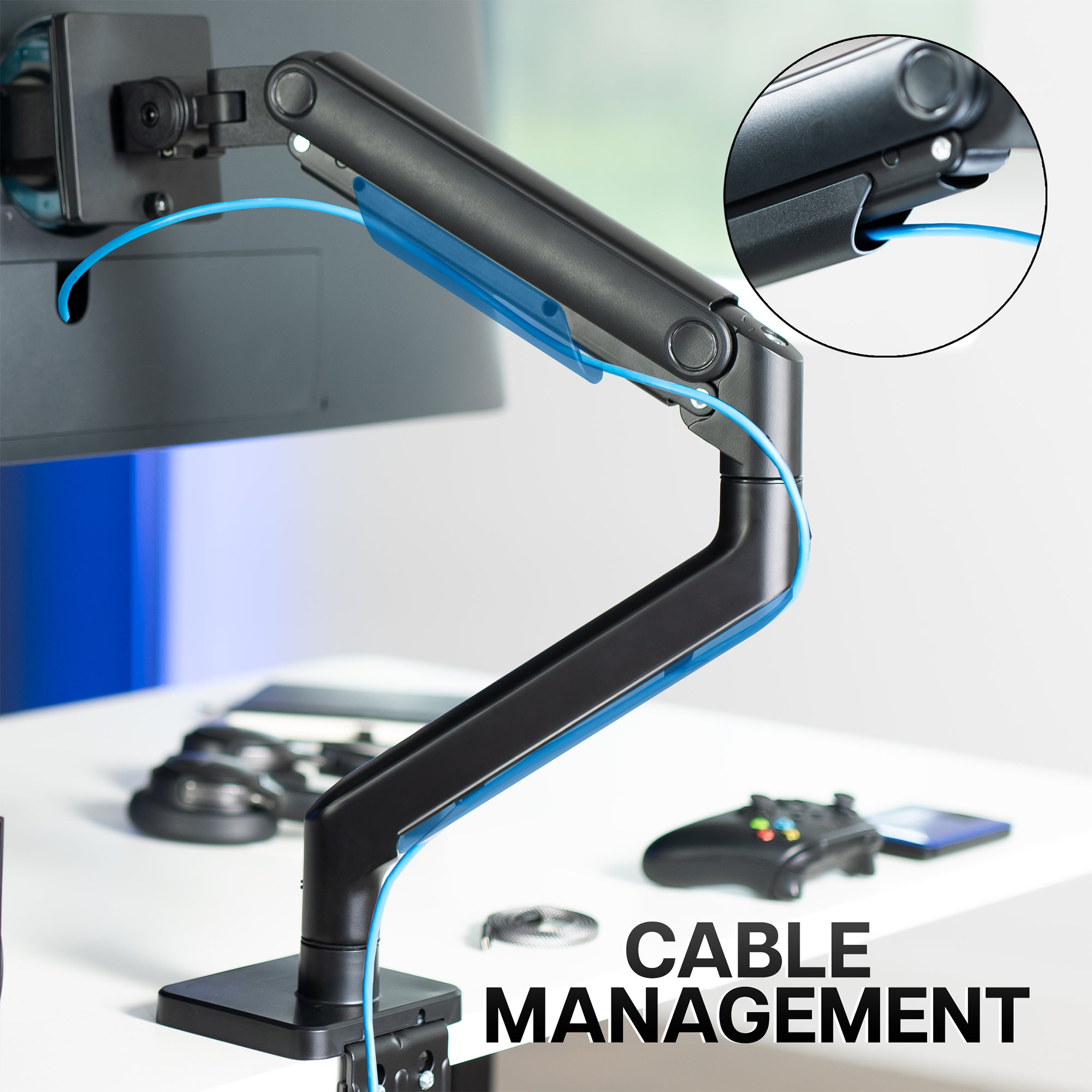 A single ultrawide computer monitor attached to a pneumatic arm desk mount with text on cable management features.