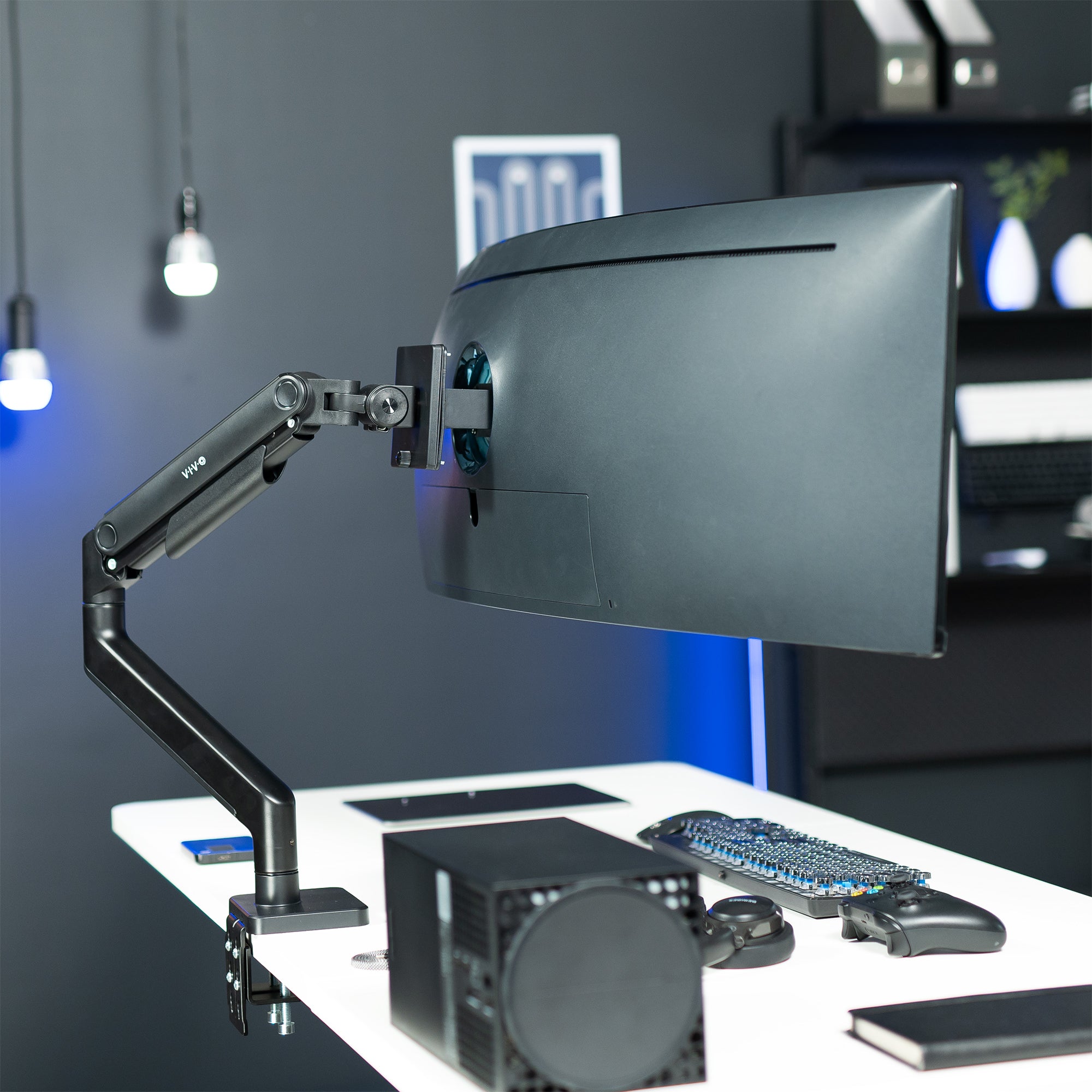 A single ultrawide computer monitor attached to a pneumatic arm desk mount