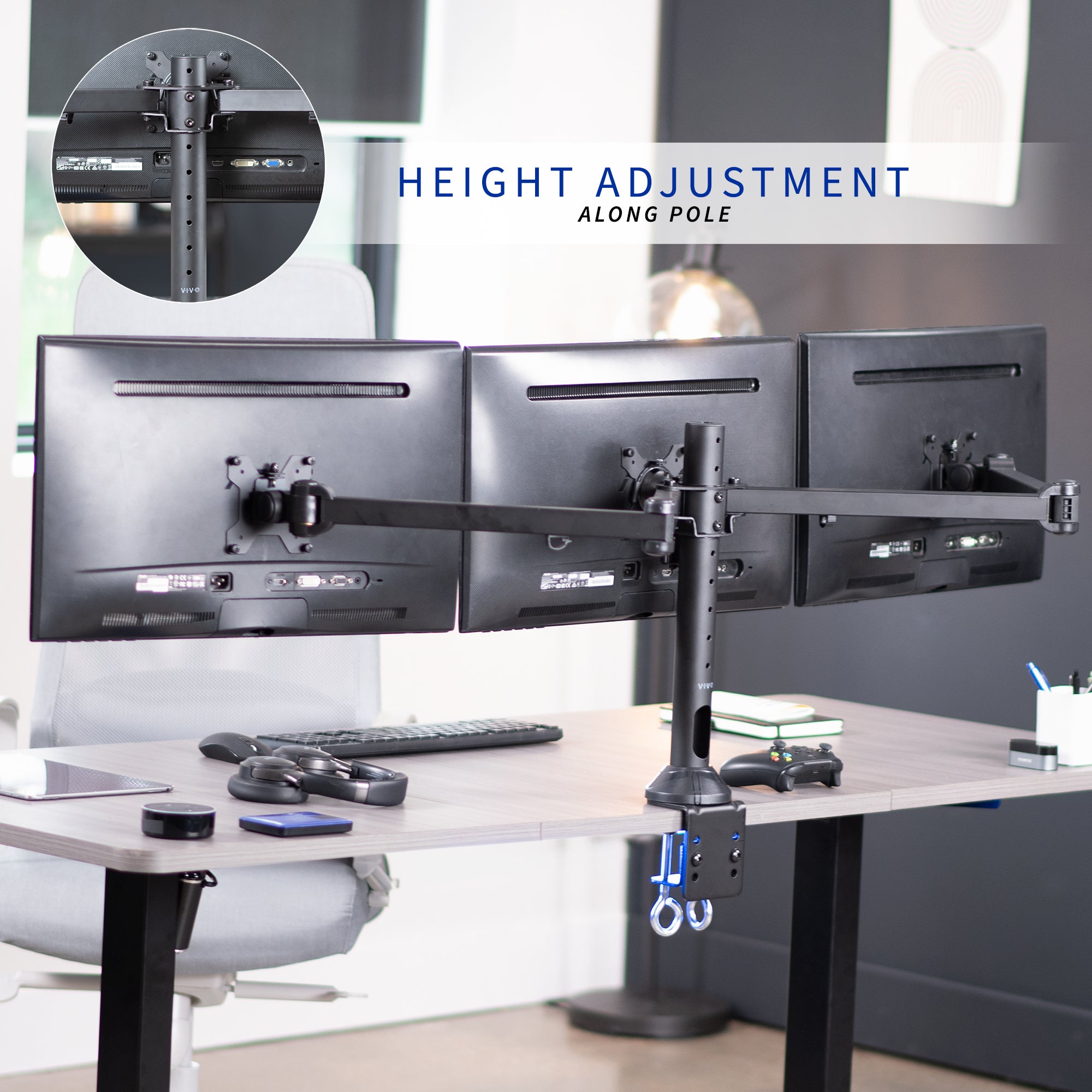 Triple monitor stand with height adjustment feature on a desk in an office setting.