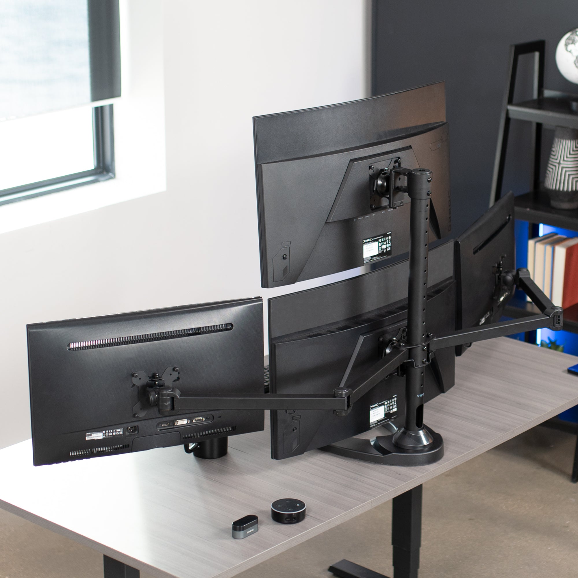 Quad Monitor Desk Stand on desk in office space.
