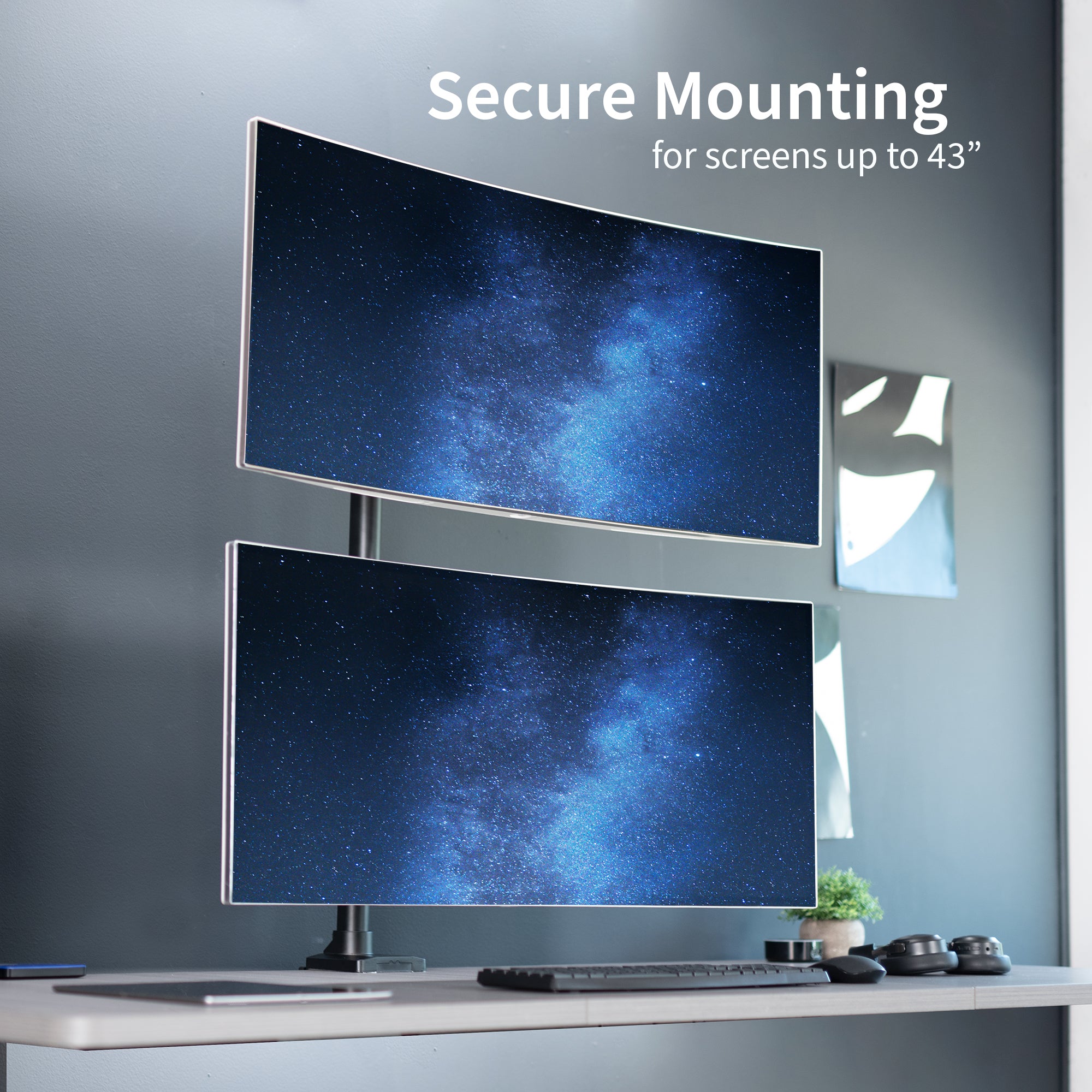 Stacked vertical dual monitor ultrawide desk mount with extending arms. Height adjustable with tilt, swivel, and integrated cable management.